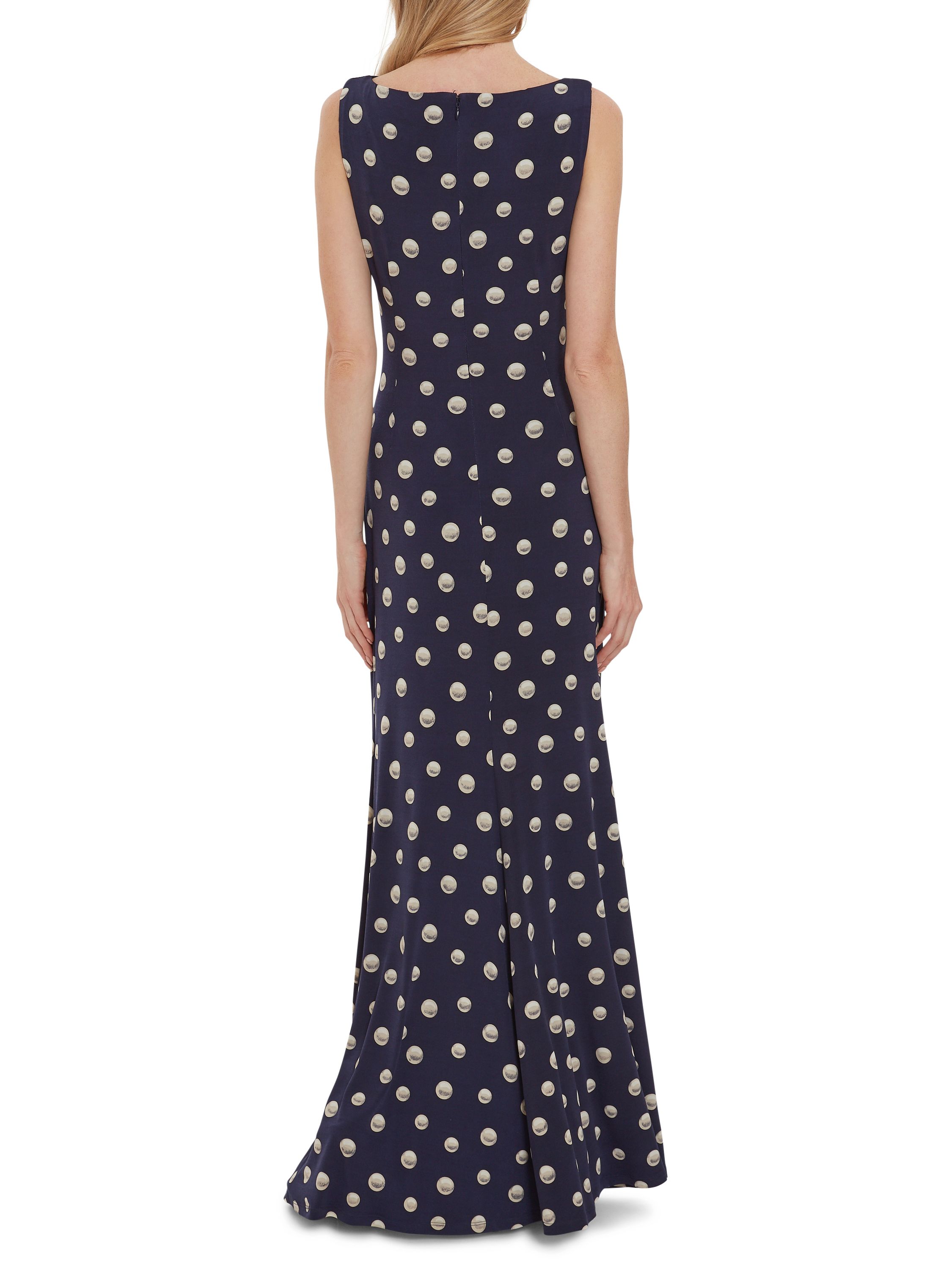 This maxi dress by Gina Bacconi is a showstopper of a piece. This piece is fashioned from a luxuriously soft pearl print jersey fabric which gracefully wraps over the bodice and ruches at the side of the waist. The asymmetric drape of the dress offers you a flawless silhouette. This dress is fully lined for extra comfort and fastens using a concealed centre back zip.