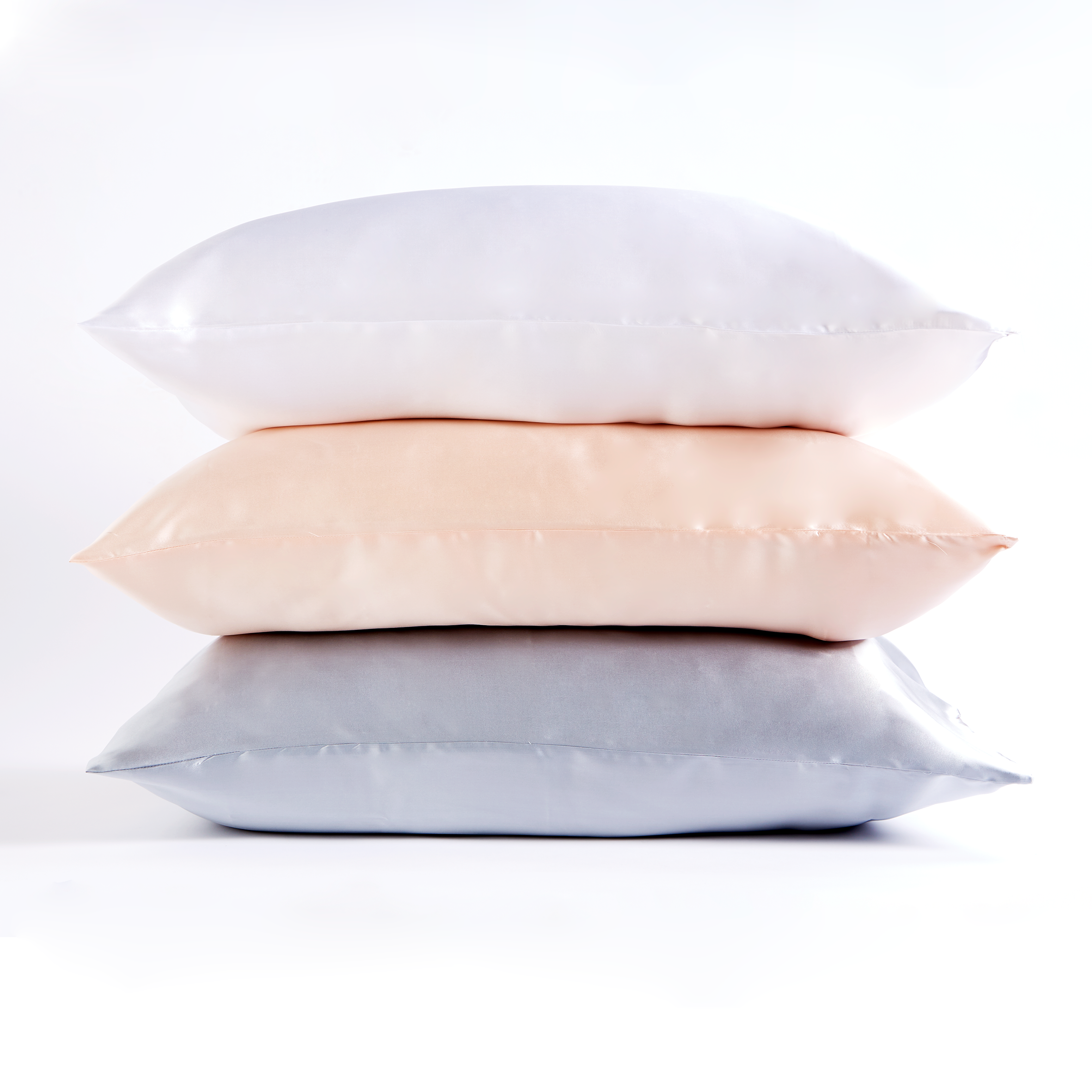 This high quality 100% Mulberry Silk pillowcase is pure sleep luxury. Due to its hypoallergenic properties, protein structure and proven beauty aiding benefits, silk retains moisture which helps to reduce wrinkles, fine lines and maintains healthy hair whilst you sleep. Silk is naturally resistant to dust mites, mould and mildew making it the ideal option for allergy sufferers. Silk contains 18 amino acids that help counter the effects of aging on facial skin. Reduced friction means less drag on skin reducing wrinkles and creases. Natural moisture will not be absorbed from your skin so hydration is preserved across the pillow. Natural proteins in silk help to maintain the natural oils in your hair and keep it smooth throughout the night.
One silk pillowcase comes in a beautiful gift box ideal for that perfect present.
Material: 100% Mulberry Silk Colours: Available in white, blush and ice grey.
Dimensions:  Box: 14cm x 9cm Pillowcase: Housewife 55cm x 75cm
Washing instructions: Hand wash or delicate machine wash with a gentle non-biological detergent.