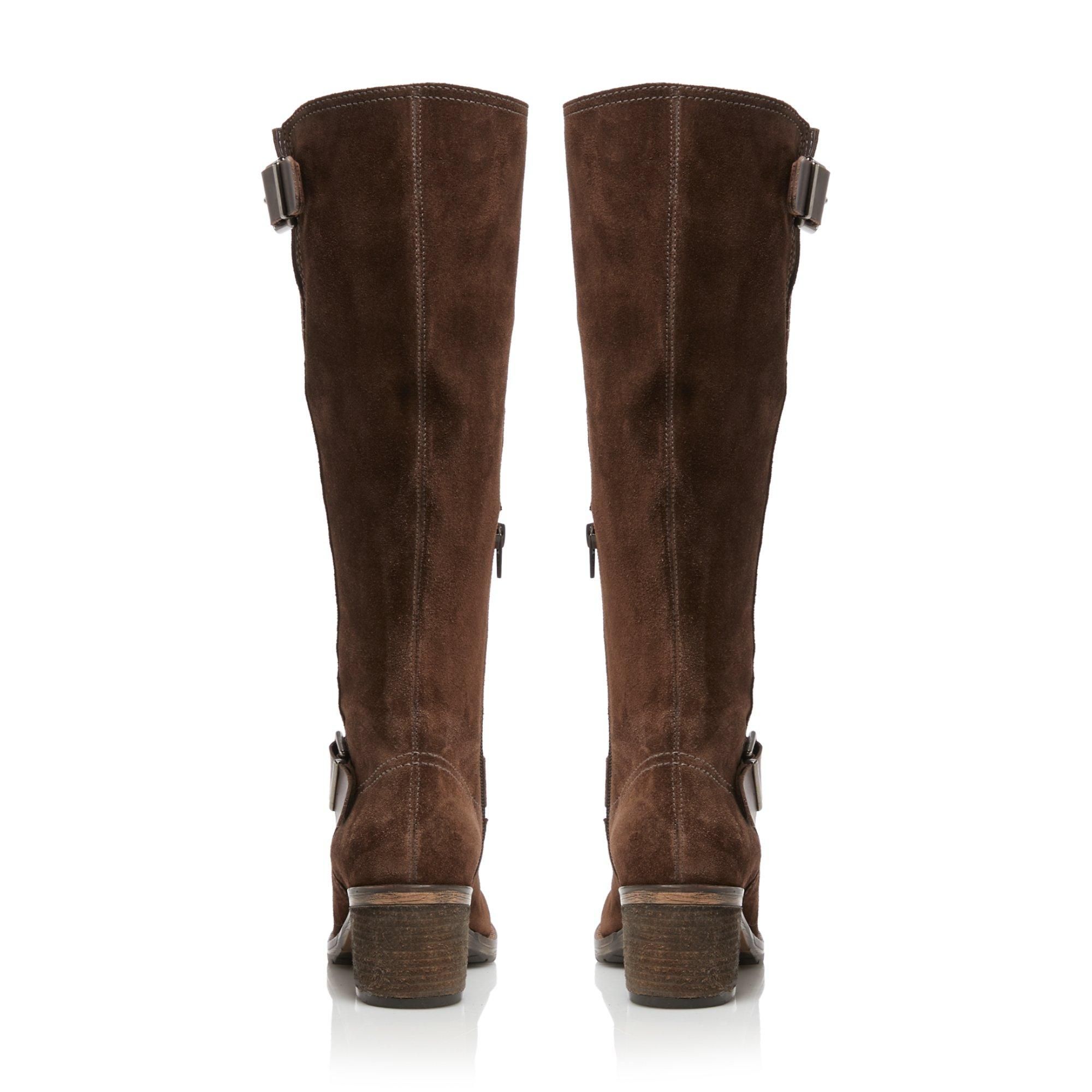 Dune London takes cues from the wild west for its Twiggie knee-high boots. Featuring double buckle details and classic contrast wingtip stitching. They're set on a mid-block heel and secure with a neat side zip fastening.