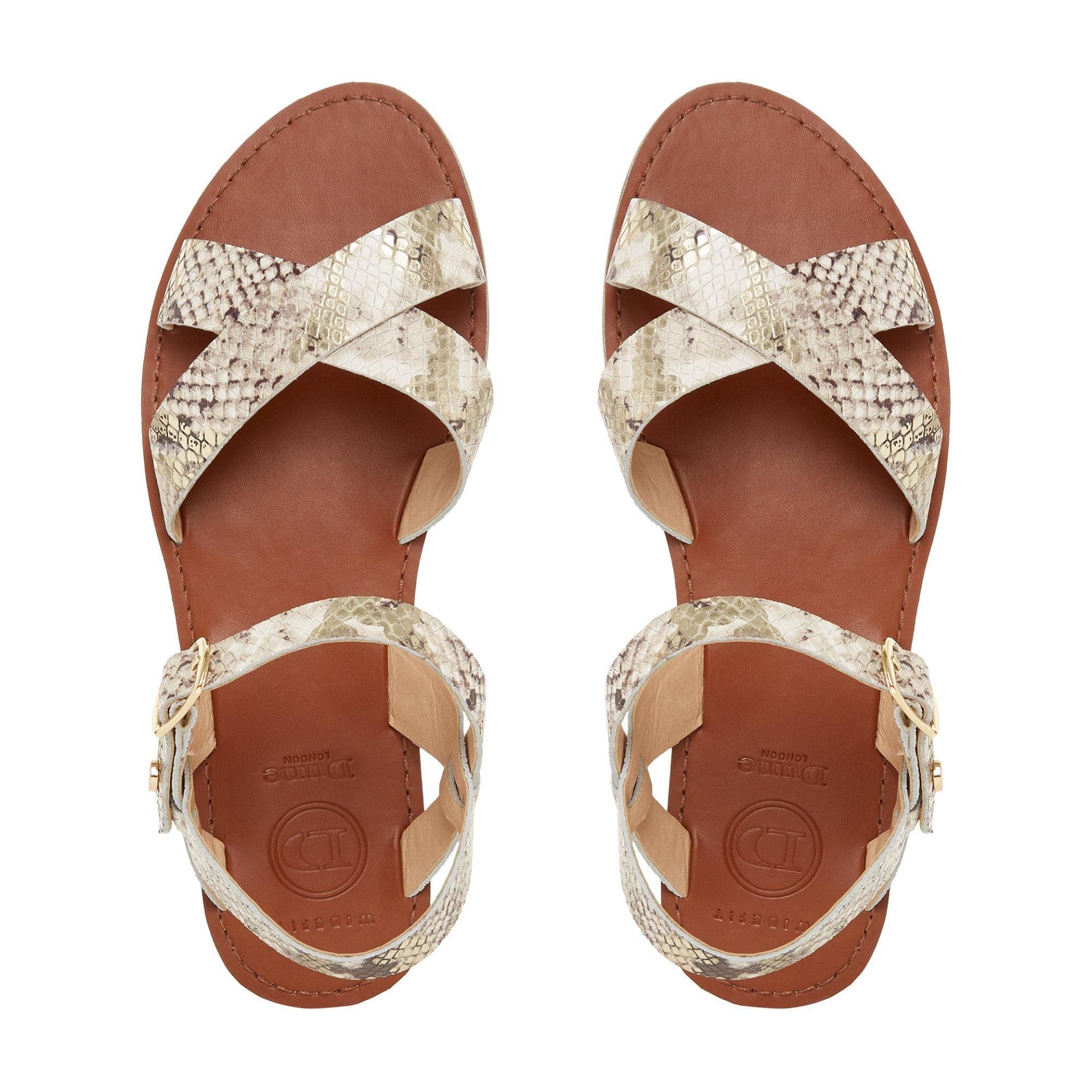 Upgrade your summer style with the WF Lavell sandal by Dune London. Designed with chic cross-over straps and a comfortable flat sole. It's complete with an ankle strap and gold-tone buckle fastening.