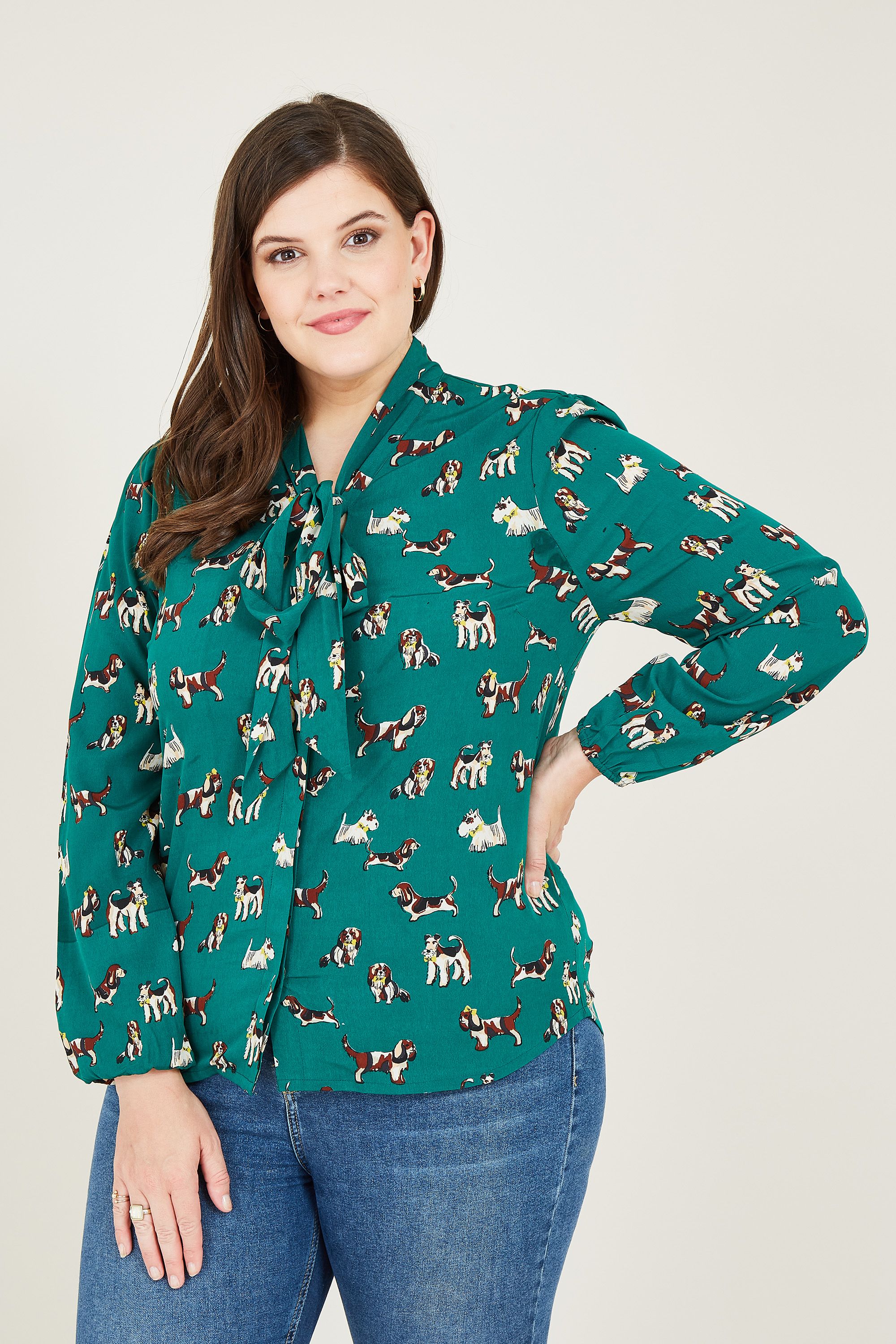 At Yumi, we love a fun print. That's why we've created our Plus Size Dog Pussy Bow Blouse. Skilfully made from light fabric, it comes with classically long sleeves and a fun tie neckline. Finished with a soft-touch feel, it's perfect for teaming with your pair of jeans.
