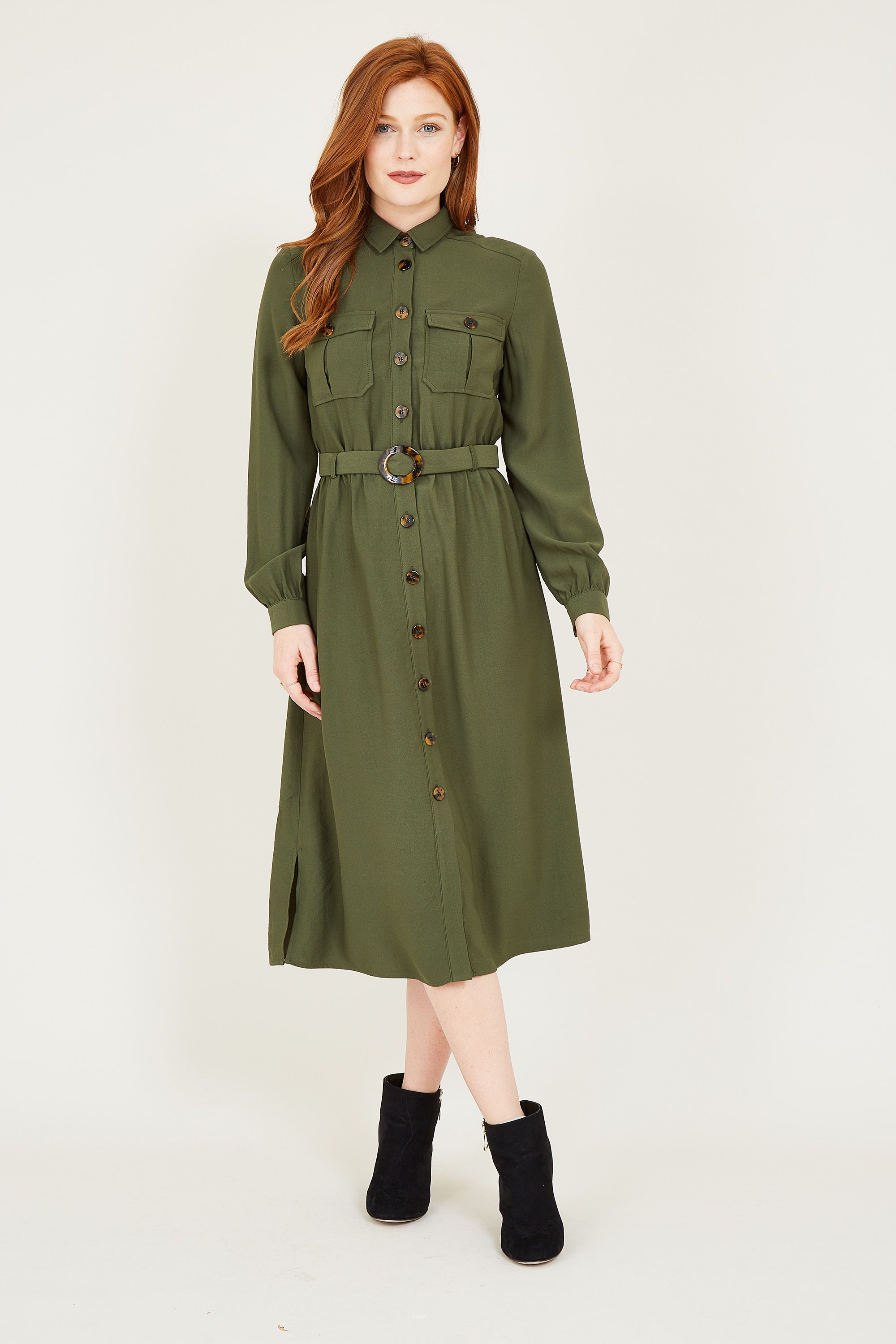 Stand to attention (and sit in total comfort) in this Military Shirt Dress; perfect for weekends and off-duty moments. With a refined knee-length cut, it features long rolled sleeves, a button front, and a flattering self-tie waist. Complete with a touch of khaki green charm, complement your look with knee-high boots.