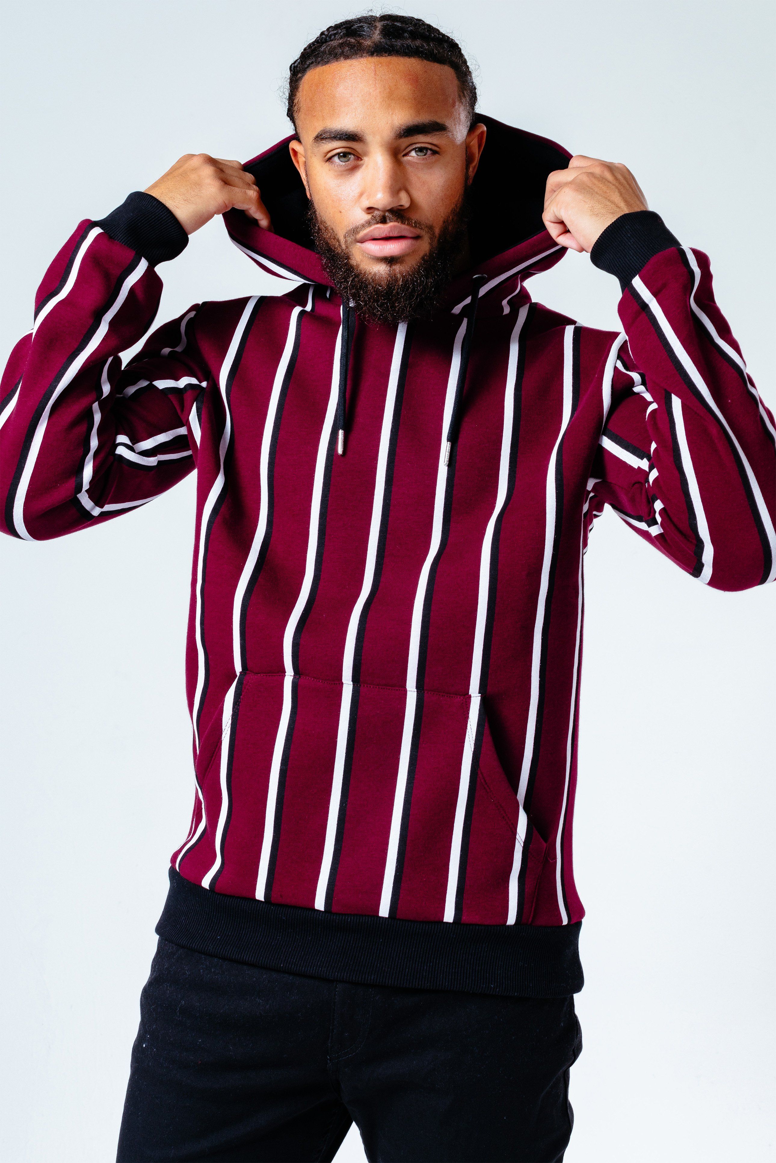 The HYPE. burgundy stripe men's hoodie pairs perfectly with the HYPE. men's black joggers for an off-duty relaxed look. Coming in with a burgundy, white and black colour palette in an 80% cotton and 20% polyester fabric base for supreme comfort. Designed in our standard men's pullover shape, with a fixed hood, kangaroo pocket, elastic waist and ribbed cuffs for a snug feel, finished with an embroidered embossed patch on the sleeve. Machine wash at 30 degrees.