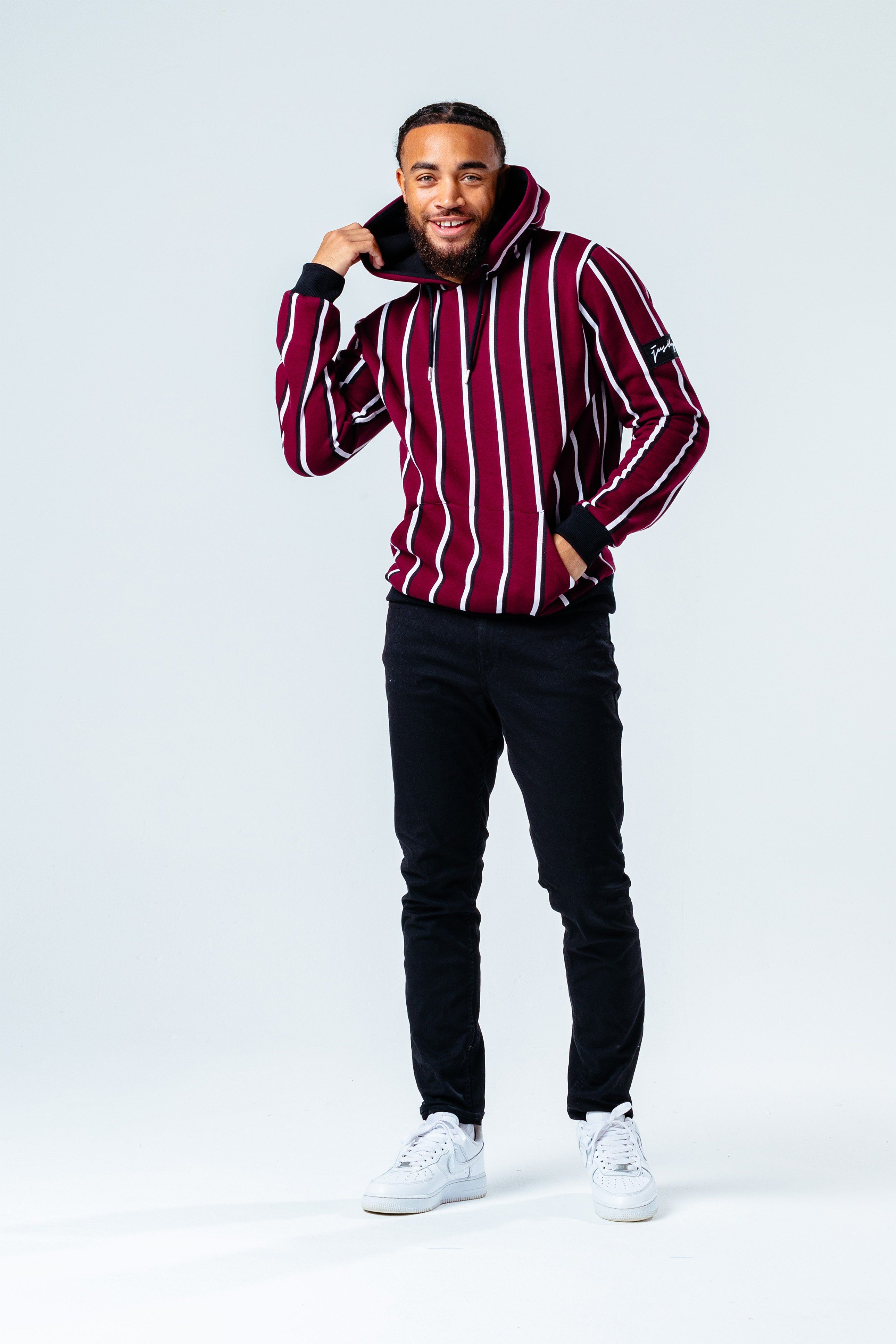 The HYPE. burgundy stripe men's hoodie pairs perfectly with the HYPE. men's black joggers for an off-duty relaxed look. Coming in with a burgundy, white and black colour palette in an 80% cotton and 20% polyester fabric base for supreme comfort. Designed in our standard men's pullover shape, with a fixed hood, kangaroo pocket, elastic waist and ribbed cuffs for a snug feel, finished with an embroidered embossed patch on the sleeve. Machine wash at 30 degrees.