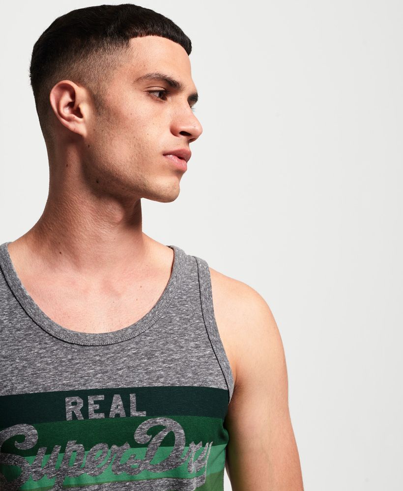 Superdry men's Vintage Logo cali stripe vest top. An essential this season, the Vintage Logo cali stripe vest top features a stripe logo graphic across the chest and has been completed with a small logo tab in the side seam. Pair with shorts and flip flops to complete the look.