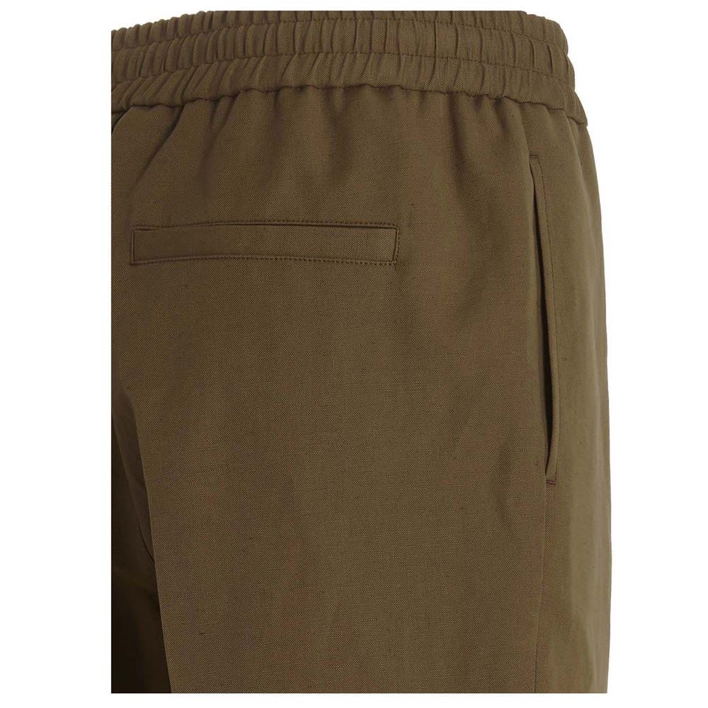Cotton pants with an elastic waistband and a central crease.