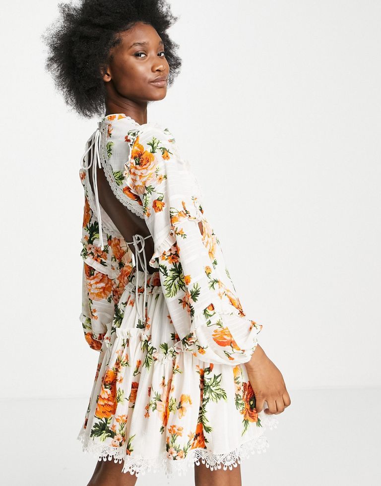 Mini dress by ASOS DESIGN Big floral energy Tiered design Plunge neck Volume sleeves Open back with tie fastening Contrast trims Regular fit Sold by Asos