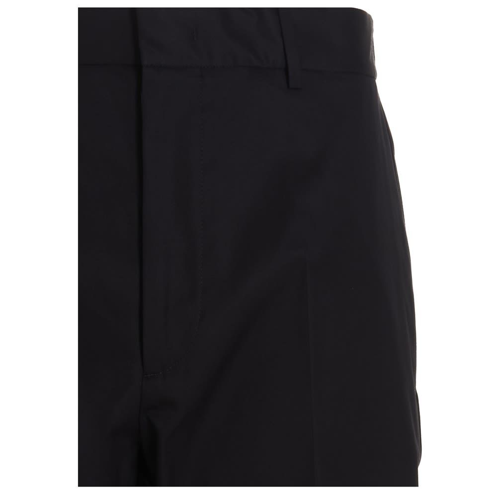'Alem' cotton trousers with an elastic at the back and a zip and hook-and-hook closure.