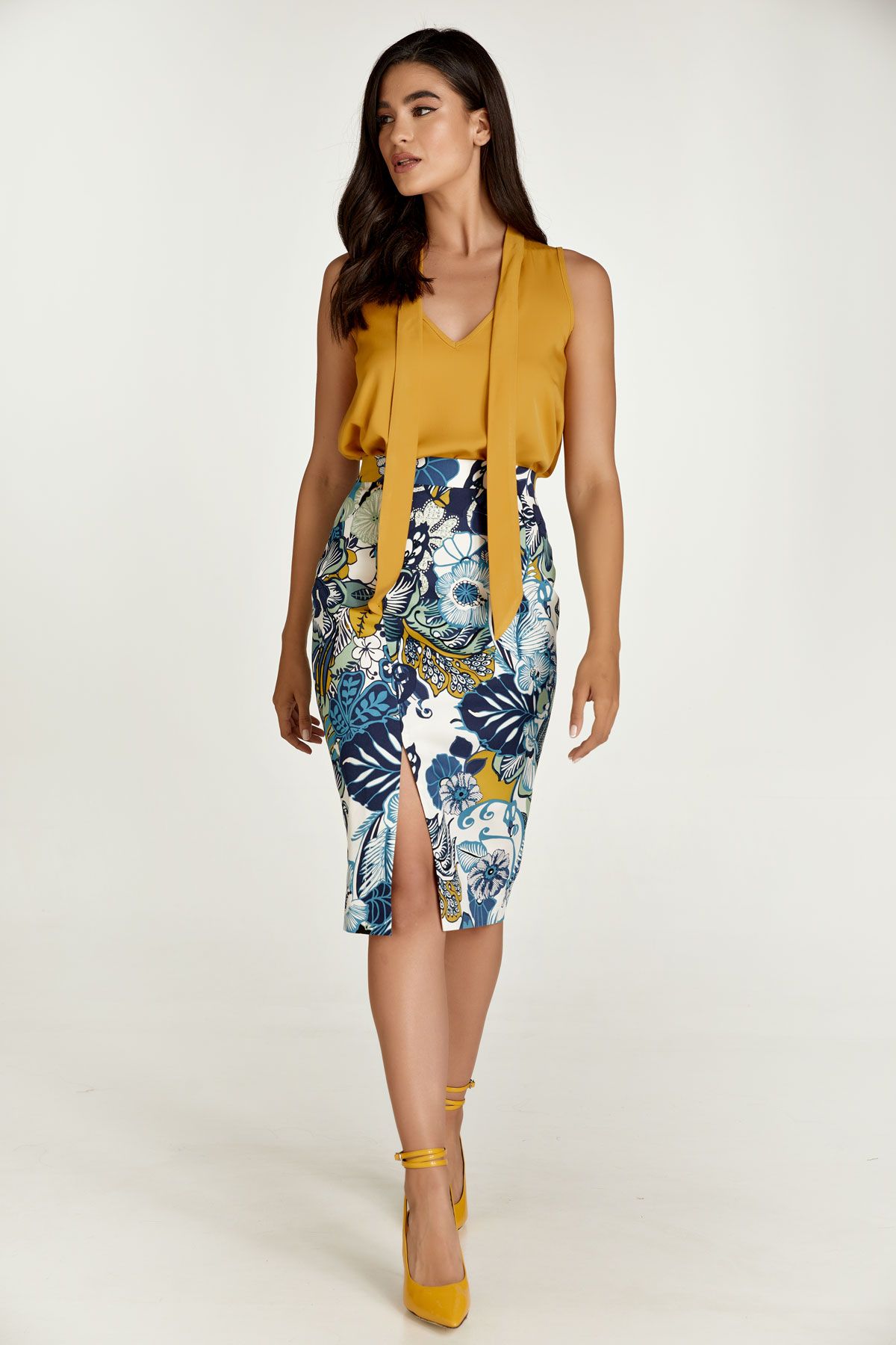This pencil skirt is crafted in floral stretch gabardine fabric in blue and green shades. It has a 4cm wide waistband in the same fabric with darts below in the back. There is an off-centre slit in the front. It fastens in the back with a concealed zip. This pencil skirt is knee length and has an ecru lining. Heels and an off-shoulder top will take this skirt and you for a night on the town! This skirt is eco-friendly.
