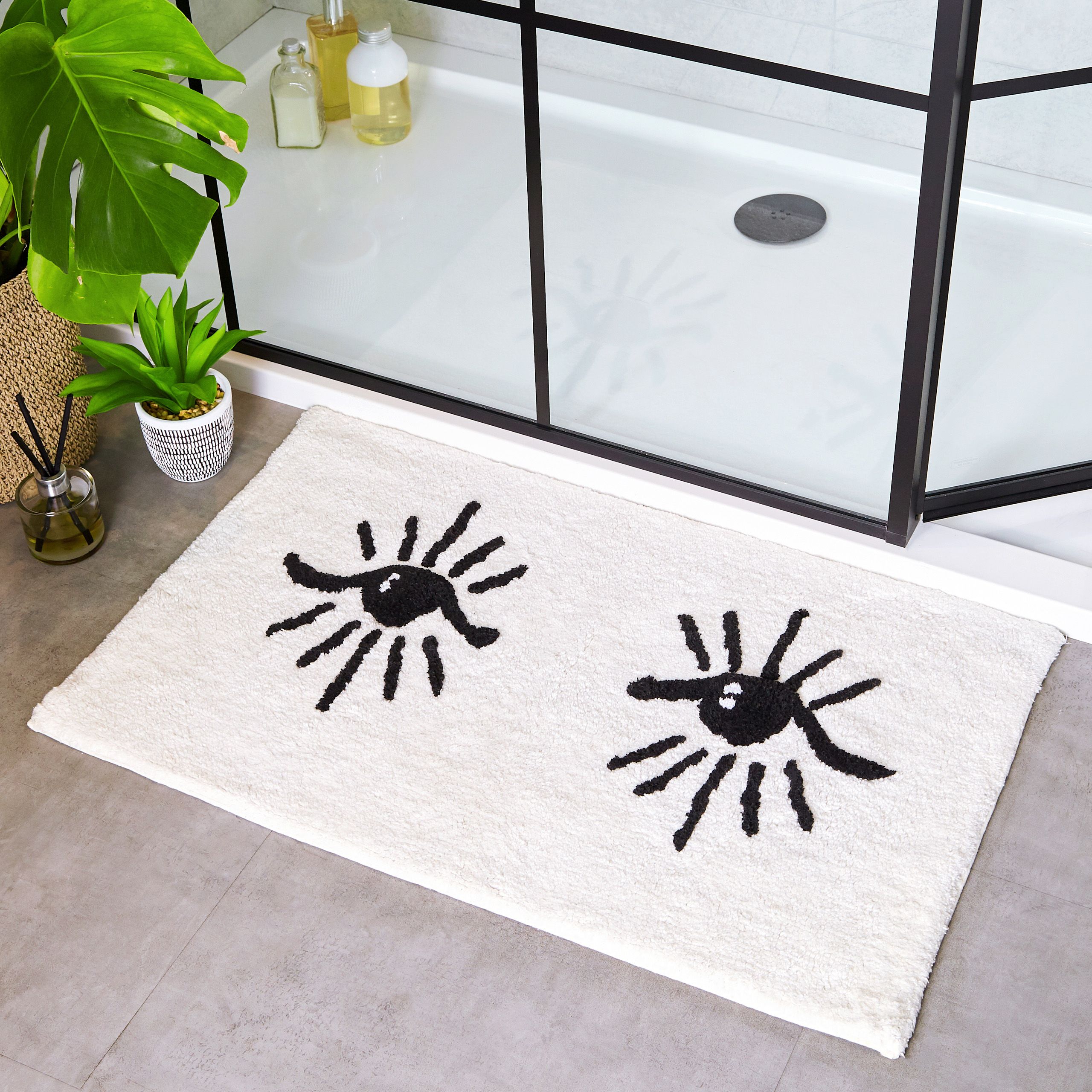 Featuring an abstract eye design, in three stunning colourways. Made from 100% Cotton, making this bath mat incredibly soft under foot. This bath mat has an anti-slip quality, keeping it securely in place on your bathroom floor. The 1800 GSM ensures this bath mat is super absorbent preventing post-bath or shower puddles.