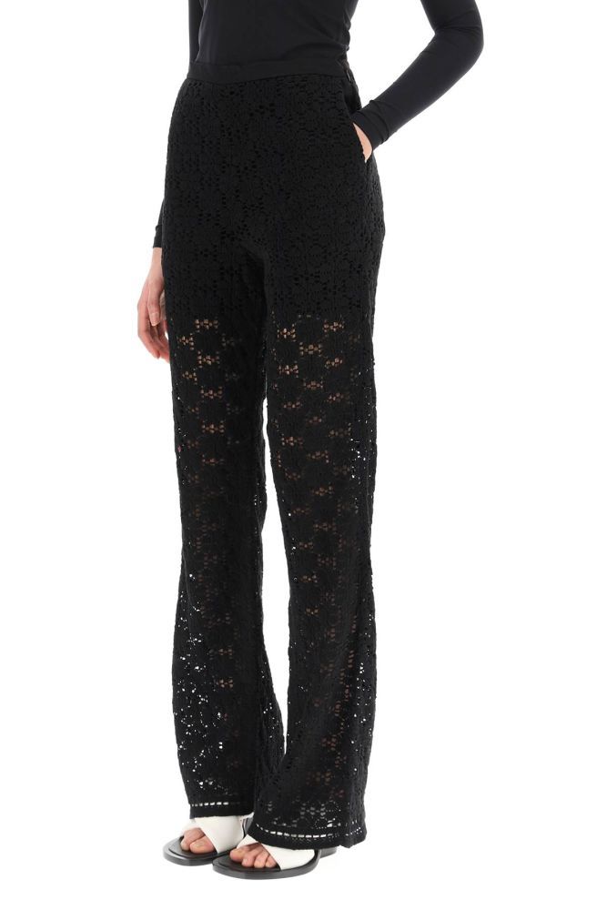Jil Sander high-waisted trousers in macramé cotton knit with a floral pattern, cut to a slim fit with straight leg. Side zip closure, slash pockets. Lined with shorts. The model is 177 cm tall and wears a size DE 34.