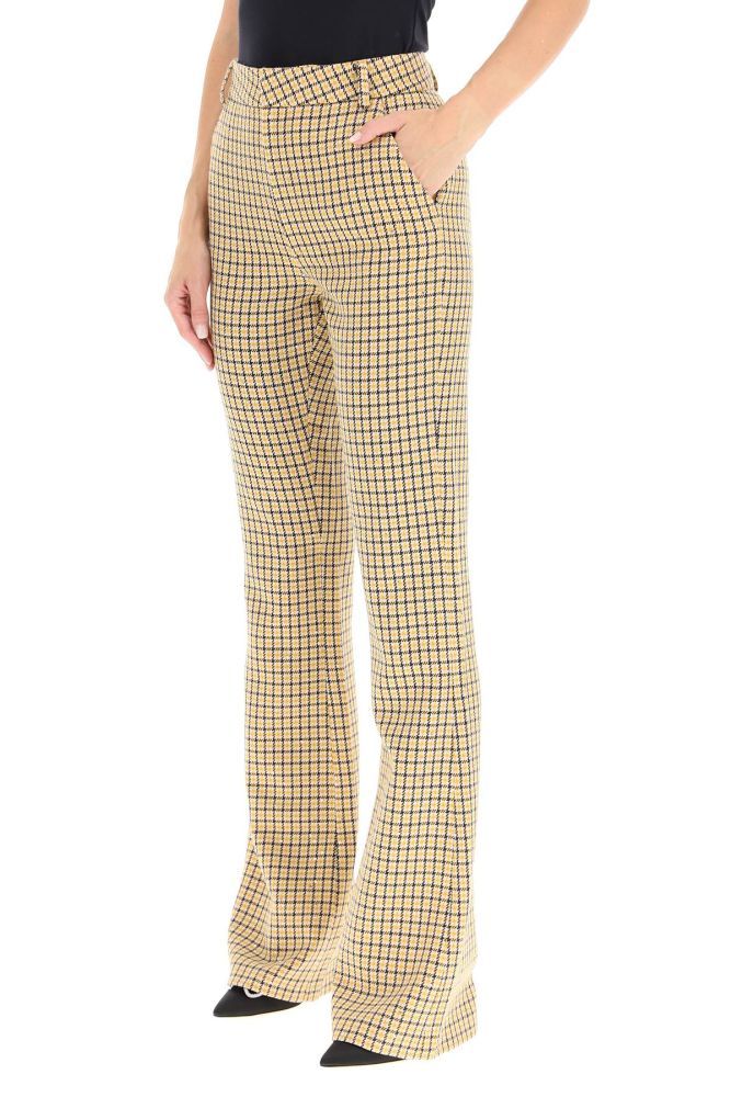 ALESSANDRA RICH wool blend trousers decorated by a tattersall pattern and all-over small sequins. High-waisted bootcut design with side slash pockets, a rear welt pocket, and concealed zip and hook closure. The model is 177 cm tall and wears a size IT 40.