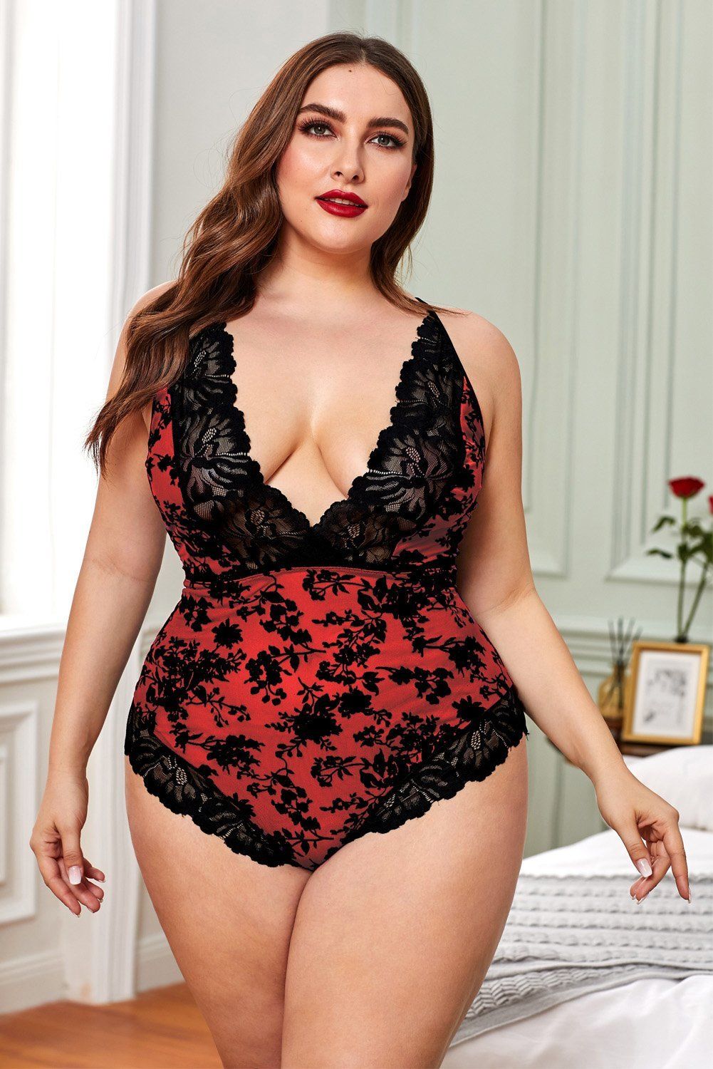 Add a daring yet dainty touch to your lingerie collection with this flirty . plus size teddy Plunging V-neckline with a sheer lace trim Adjustable criss-cross spaghetti straps with a tie back closure All over flocked purple and black floral Thin elastic waistline, a thick lace hem Satin lace-up back panel and a cheeky cut back