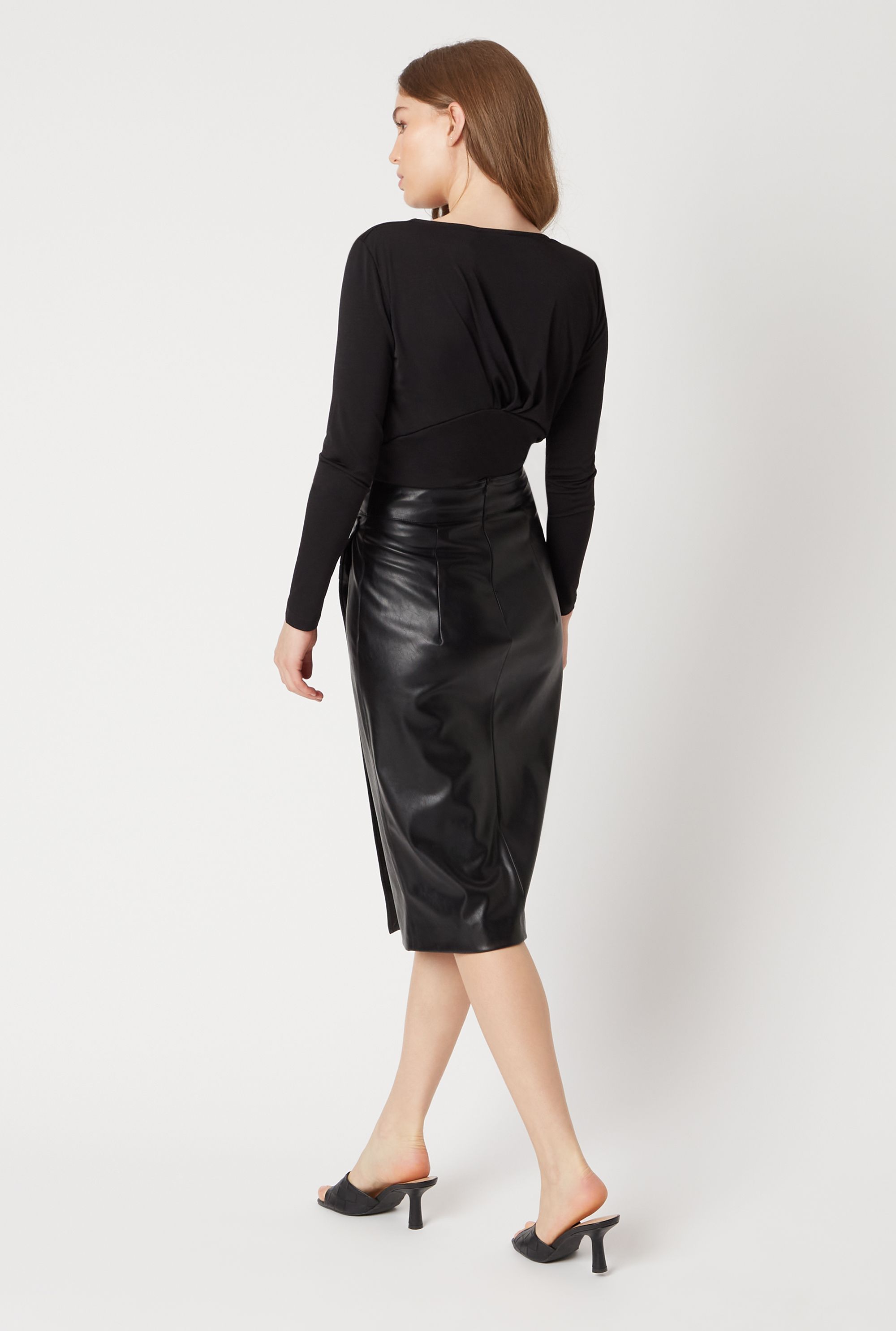 Crafted in the softest faux leather, featuring a gathered ruched high waist and finished with a side slit all the way down, this fitted midi skirt is sculpted to a slim flattering fit, falling below the knee.  A must for all year round to love season after season for an elegant on trend wardrobe essential.