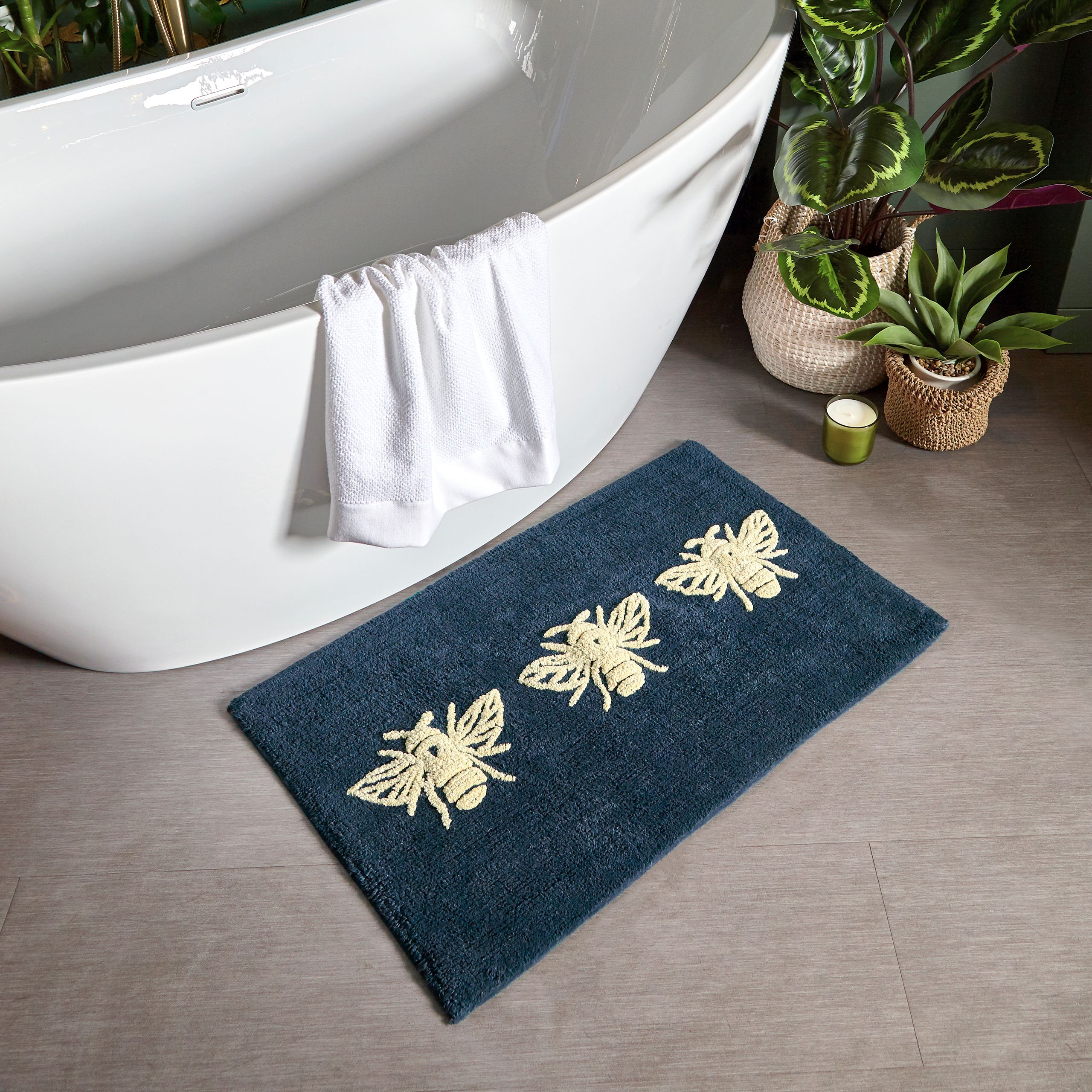 Featuring a tufted Bumblebee design on a navy blue cotton fabric. Made from 100% Cotton, making this bath mat incredibly soft under foot. This bath mat has an anti-slip quality, keeping it securely in place on your bathroom floor. The 1800 GSM ensures this bath mat is super absorbent preventing post-bath or shower puddles.
