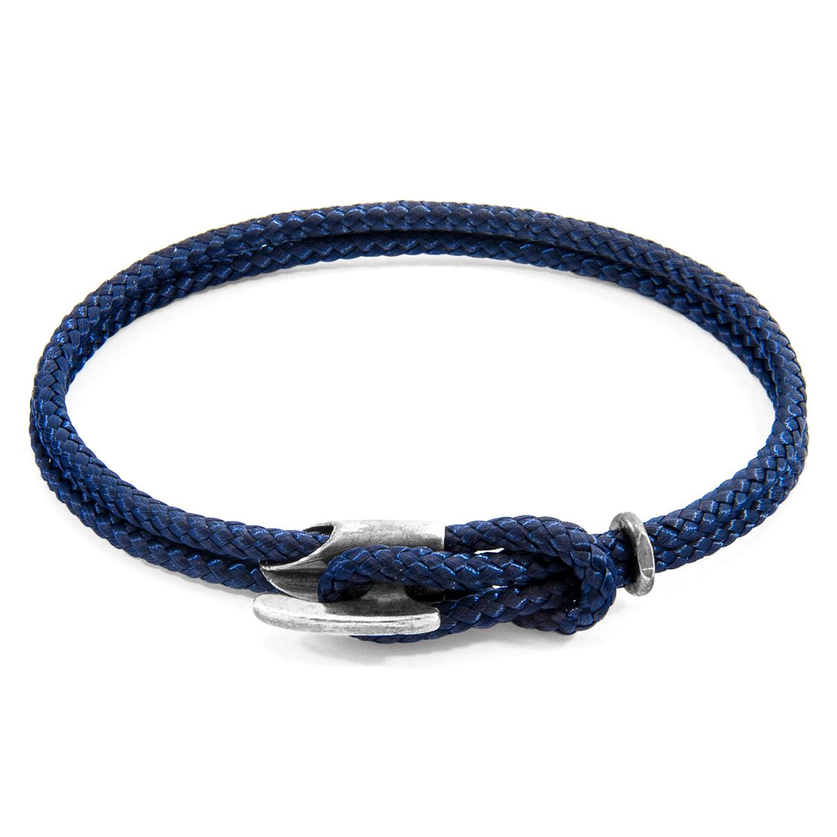 The Navy Blue Padstow Silver and Rope Bracelet was both designed and skilfully handcrafted completely in Great Britain, In Quality We Trust. For the Modern Journeyman (and woman), ANCHOR & CREW takes ownership of an exploratory lifestyle and enjoys the Happy-Good Life. Combining British craft manufacturing with a discerning modern-minimalist style, this ANCHOR & CREW bracelet features:

3mm diameter performance Marine Grade polyester and nylon rope (GB) 
Secure solid .925 sterling silver bar-hook cleat (GB)

SIZING
This bracelet is available in four bracelet lengths, 17cm, 19cm, 21cm or 23cm in circumference. To take the bracelet on or off your wrist, simply (un)clutch the rope loop from the bar-hook cleat. As pictured, the bracelet is most secure when the rope loop is fed through the smaller loop that emerges beyond the clasp.