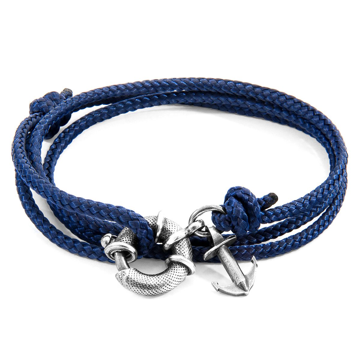 The Navy Blue Clyde Anchor Silver and Rope Bracelet was both designed and skilfully handcrafted completely in Great Britain, In Quality We Trust. For the Modern Journeyman (and woman), ANCHOR & CREW takes ownership of an exploratory lifestyle and enjoys the Happy-Good Life. Combining British craft manufacturing with a discerning modern-minimalist style, this ANCHOR & CREW bracelet features:

3mm diameter performance Marine Grade polyester and nylon rope (GB) 
Secure solid .925 sterling silver lifeboat clasp and drop anchor (GB)  

SIZING
This bracelet is one size fits all, with the rope able to extend or tighten to suit your wrist size. To take the bracelet on or off your wrist, simply slide the one adjustable knot around the rope to make the loop size smaller or larger. Once set, keep the loop size consistent and simply slide the latch within the clasp and feed the rope into or out of the toggle.