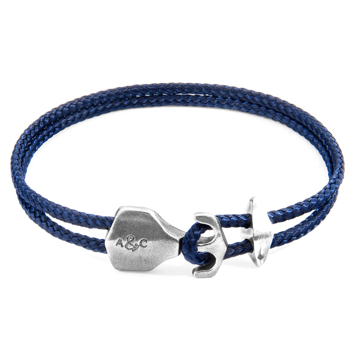 The Navy Blue Delta Anchor Silver and Rope Bracelet was both designed and skilfully handcrafted completely in Great Britain, In Quality We Trust. For the Modern Journeyman (and woman), ANCHOR & CREW takes ownership of an exploratory lifestyle and enjoys the Happy-Good Life. Combining British craft manufacturing with a discerning modern-minimalist style, this ANCHOR & CREW bracelet features:

3mm diameter performance Marine Grade polyester and nylon rope (GB) 
Secure solid .925 sterling silver anchor and rhombus clamp (GB) 

SIZING
This bracelet is available in four bracelet lengths, 17cm, 19cm, 21cm or 23cm in circumference. To take the bracelet on or off your wrist, simply (un)hook the clasp from the loop and slide the rhombus clamp for added security.