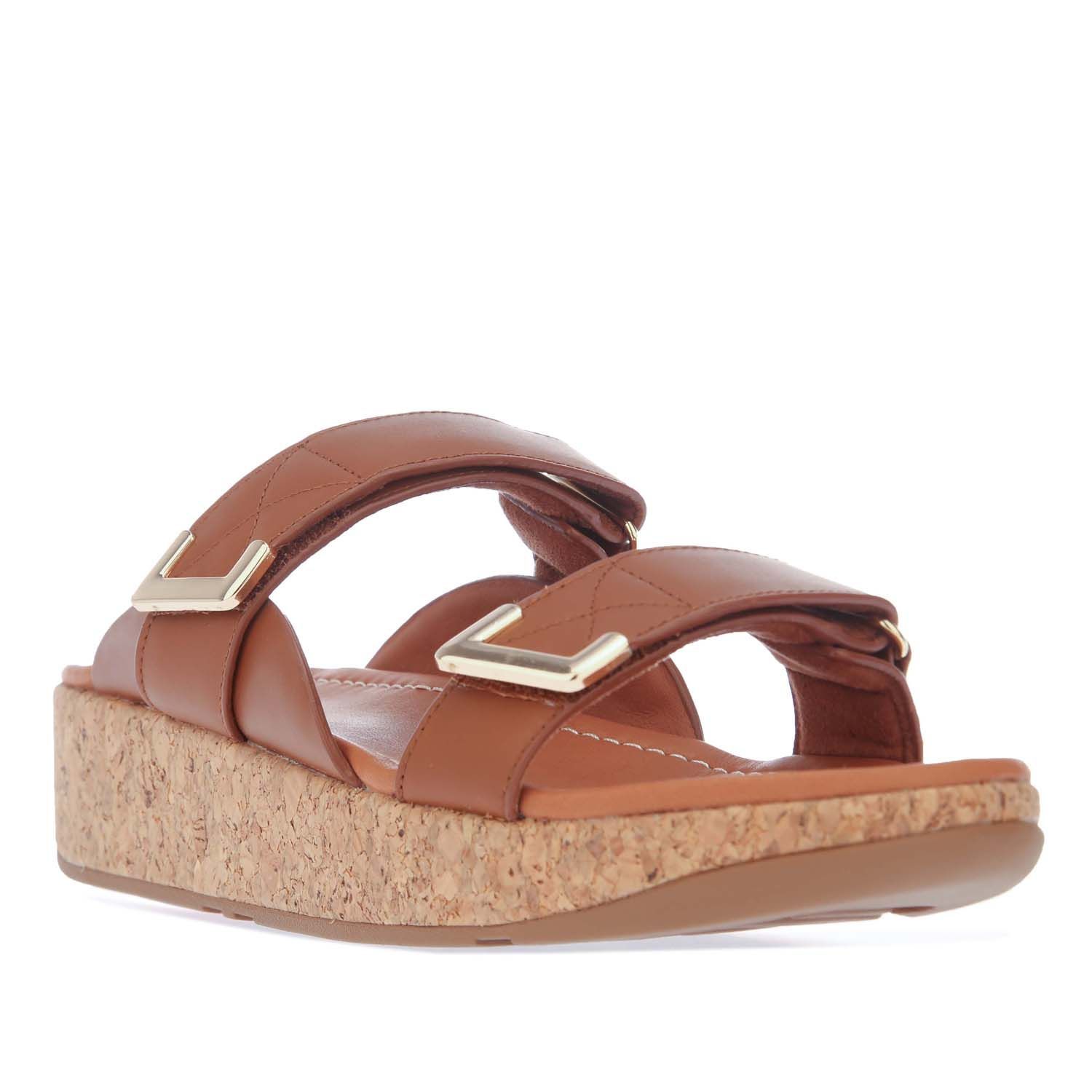 Womens Fit Flop Remi Adjustable Slide Sandals in tan.- Softly padded leather uppers.- Slip on closure.- Metal-tipped strap.- Adjustable quick-stick straps.- Leather-lined footbeds.- Supercushioned FitFlop Microwobbleboard™ midsoles.- Cork-wrapped soles. - Slip-resistant rubber outsole.- Leather upper  Leather lining and sole.- Ref: BL6592