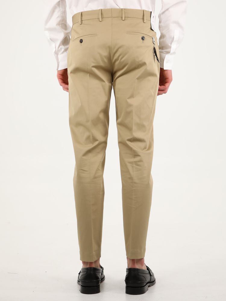 Dark beige cotton gabardine trousers with straight fit. They feature two side welt pockets, two rear pockets with button, rear charm and belt loops. The model is 184cm tall and wears size 48.  