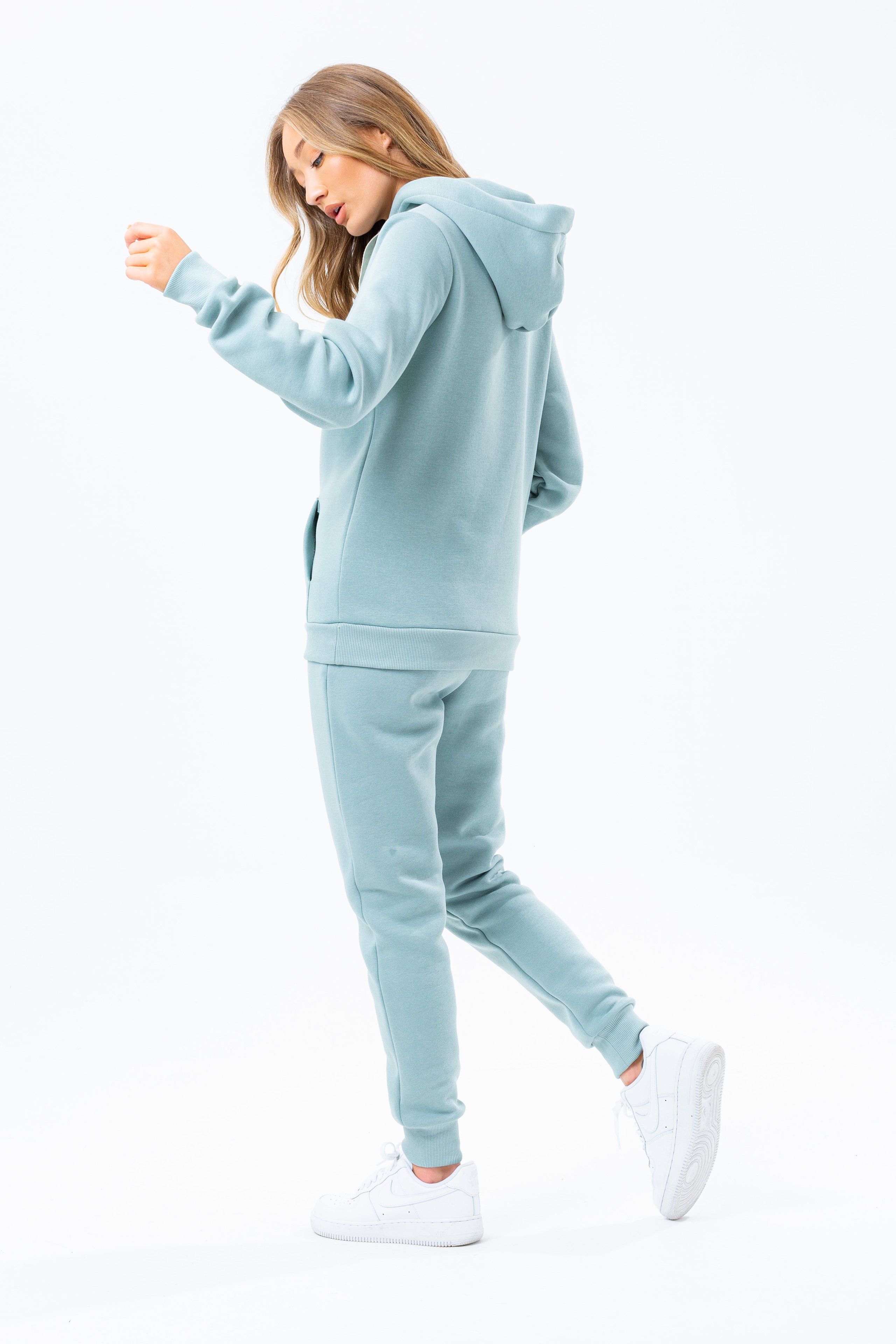 The HYPE. sage drawstring women's joggers are perfectly matched with the HYPE. sage drawstring women's hoodie to complete the look. Or opt for a cute contrasting white crop tee. Designed in 65% cotton and 35% polyester for an unreal amount of comfort. With an elasticated waistband and woven embossed drawstrings, these essential women's joggers are the perfect addition to your jogger 'drobe. Available in UK sizes from 4 to 20. Machine wash at 30 degrees.