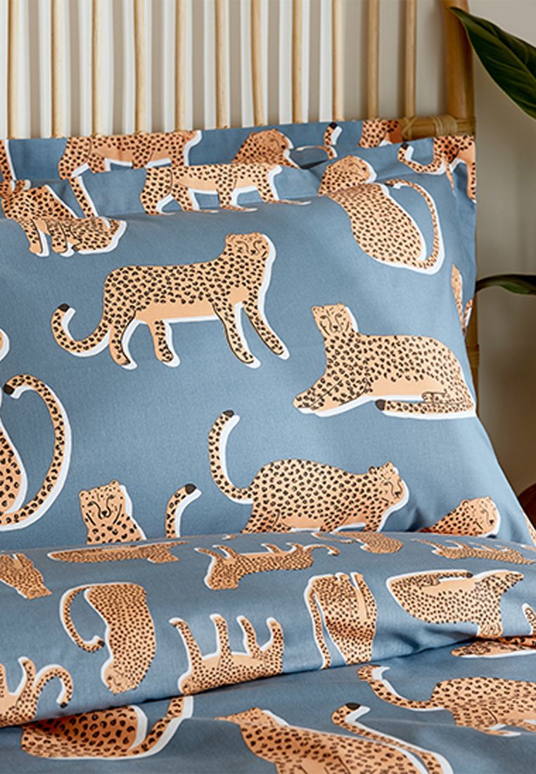 Embrace your wild side with this quirky design from the Scion design studio. Lionel the leopard is seen lounging, sitting and strolling across this striking duvet cover set. Printed on 100% cotton and available in four sizes, the duvet cover and Oxford pillowcase flip over to reveal a small-scale leopard print on the reverse. Keep an eye out for Lionel on the cotton accessory cushion, where he can be seen deep in the tropical foliage. Made in Pakistan.