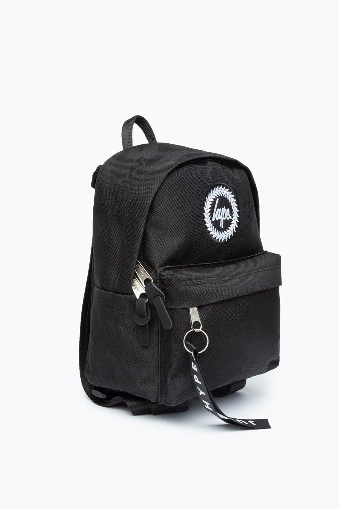 We see you checkin' out the HYPE. black mini backpack. An all over black fabric base, finished with a monochrome embossed puller tag and the iconic HYPE. crest badge. This is a mini version of our standard backpack shape. Perfect for storing your essential items while you're on the go. Wipe clean only.
