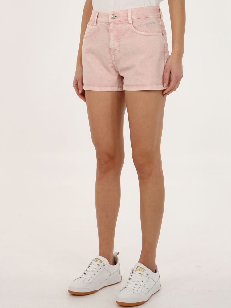 Mid-rise light pink shorts with Stella McCartney logo embroidered on the front. It features button and hidden zip fastening, five pockets design, rear logo patch and belt loops. The model is 175cm tall and wears size 27.  