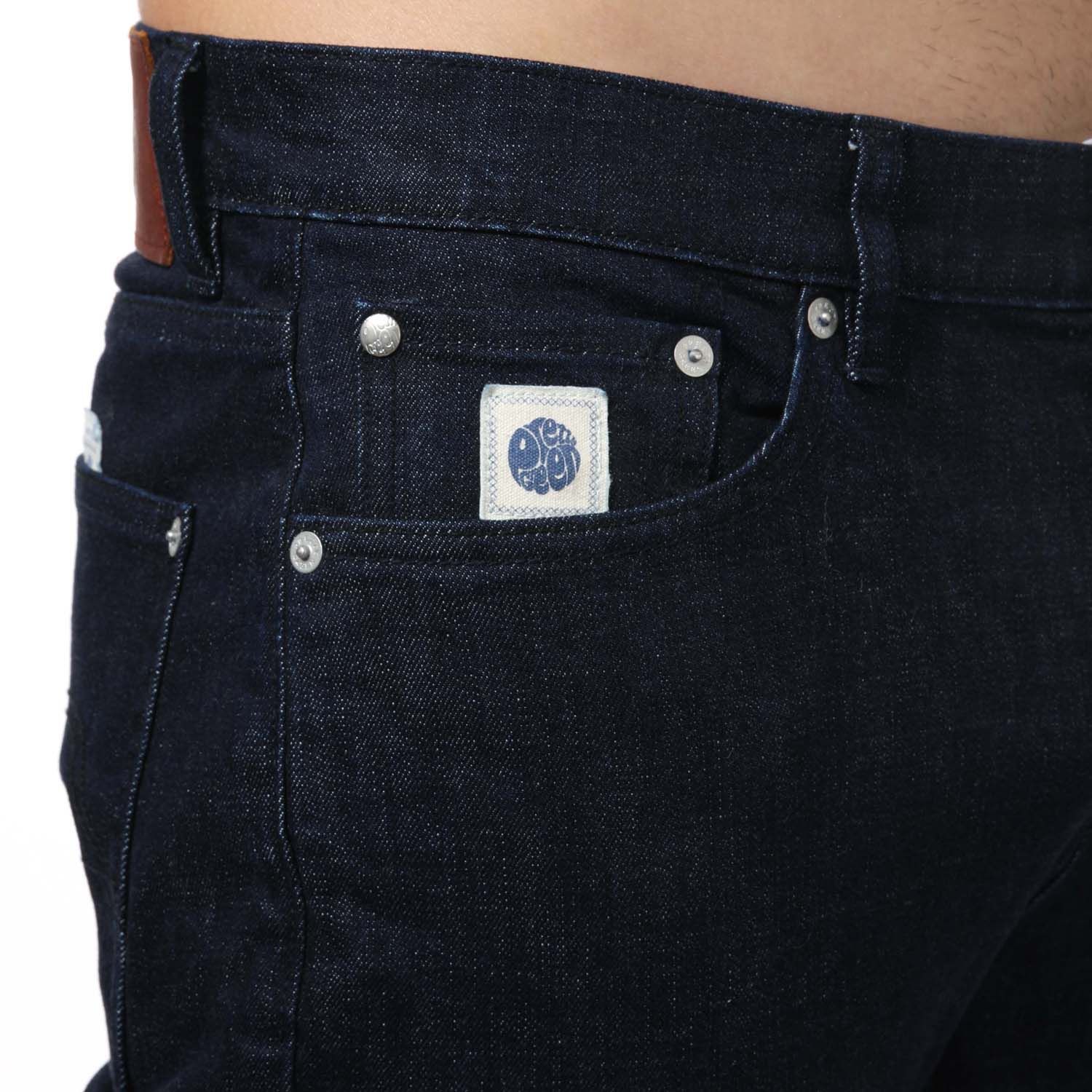 Mens Pretty Green Erwood Slim Fit Jeans in navy.- 5-pocket construction. - Concealed button fly closure.- Twin needle stitching.- Woven logo label at front waist band.- Branded arcuate at front coin pocket.- Embossed rivets and metal trims.- Hem chain stitch detail.- Complete with a branded leather patch.- Slim fit.- 99% Cotton  1% Polyurethane.- Ref: G21Q3MULEG598N