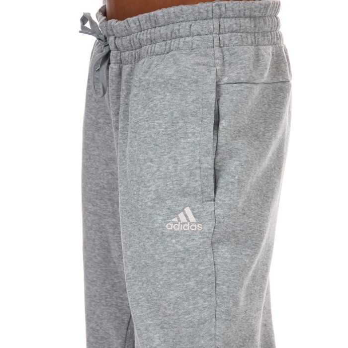 Womens adidas Essentials Comfort Jogger Pants in grey heather.- Drawcord on elastic waist.- Slip-in front pockets.- Fleece lining.- Ribbed side panels.- Regular tapered fit.- Body: 70% Cotton  30% Polyester (Recycled) . Machine wash at 30 degrees.- Ref: GE1122