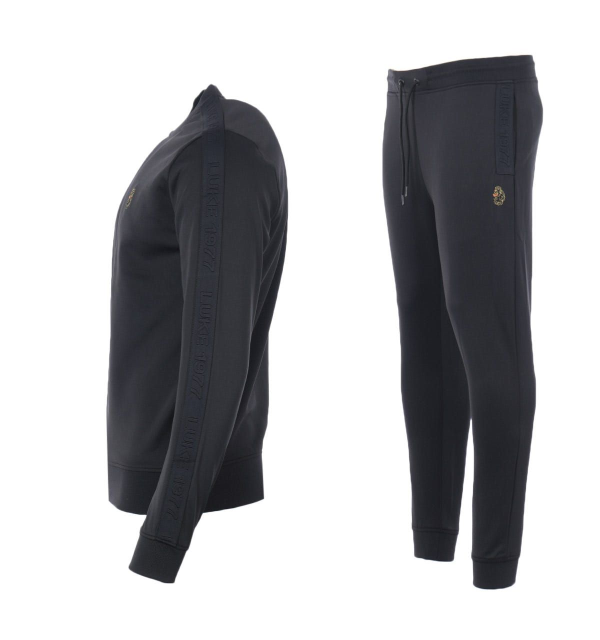 M470340SETBLKMens Trico TracksuitMens Luke 1977 Trico Tracksuit in black. - Sweatshirt:- Crew neck.- Ribbed trims.- Luke 1977 raised text tape detailing at the sleeve.- Luke lion embroidery on chest.- 94% Polyester  6% Elastane. Machine washable.- Pants:- Drawstring waist.- Ribbed cuffs.- Two front pockets. One back pocket.- Branded taping at slit pockets.- Luke 1977 logo embroidered at left thigh.- Regular Fit.- 94% Polyester  6% Elastane. - Ref: M470340SETBLK