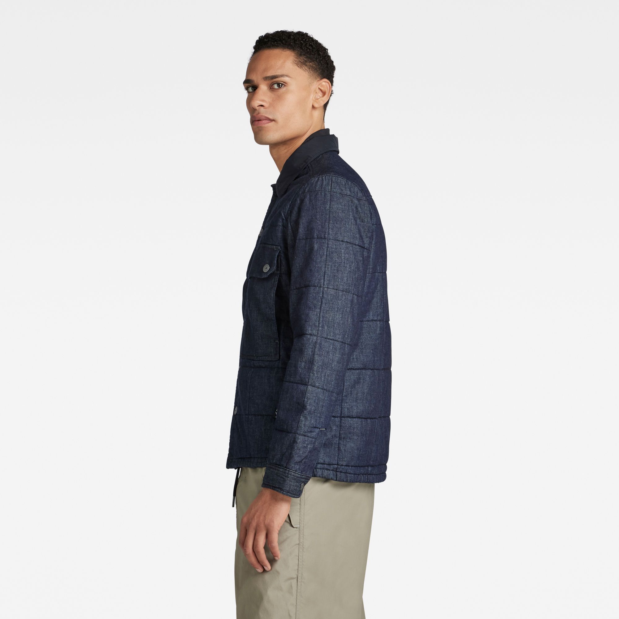 Flat collar- inner rib collar. Long sleeves, cuffed- snap button closure. Chest pocket with flap and snap button closure- side entry pocket underneath. Side seam pockets. Side slits. Snap button closure. Snap closure. A lightweight denim with a rich, uneven surface texture. Lightweight 7 oz denim. Straight