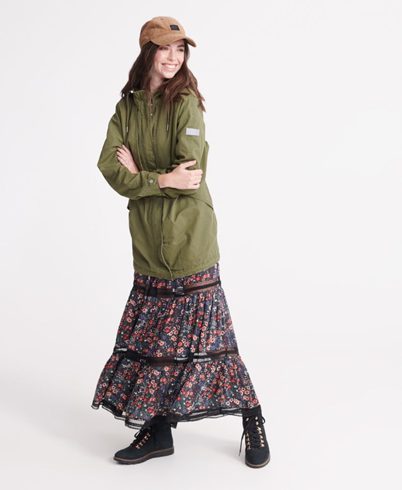 Superdry women's Adventurer Parka coat. This parka coat features, a drawstring hem, a zip and popper fastening, popper adjustable cuff, drawstring waist and hood, two front pockets, a jersey lining to the body and a batwing design to the front. Finished with Superdry branded poppers and zip pulls.