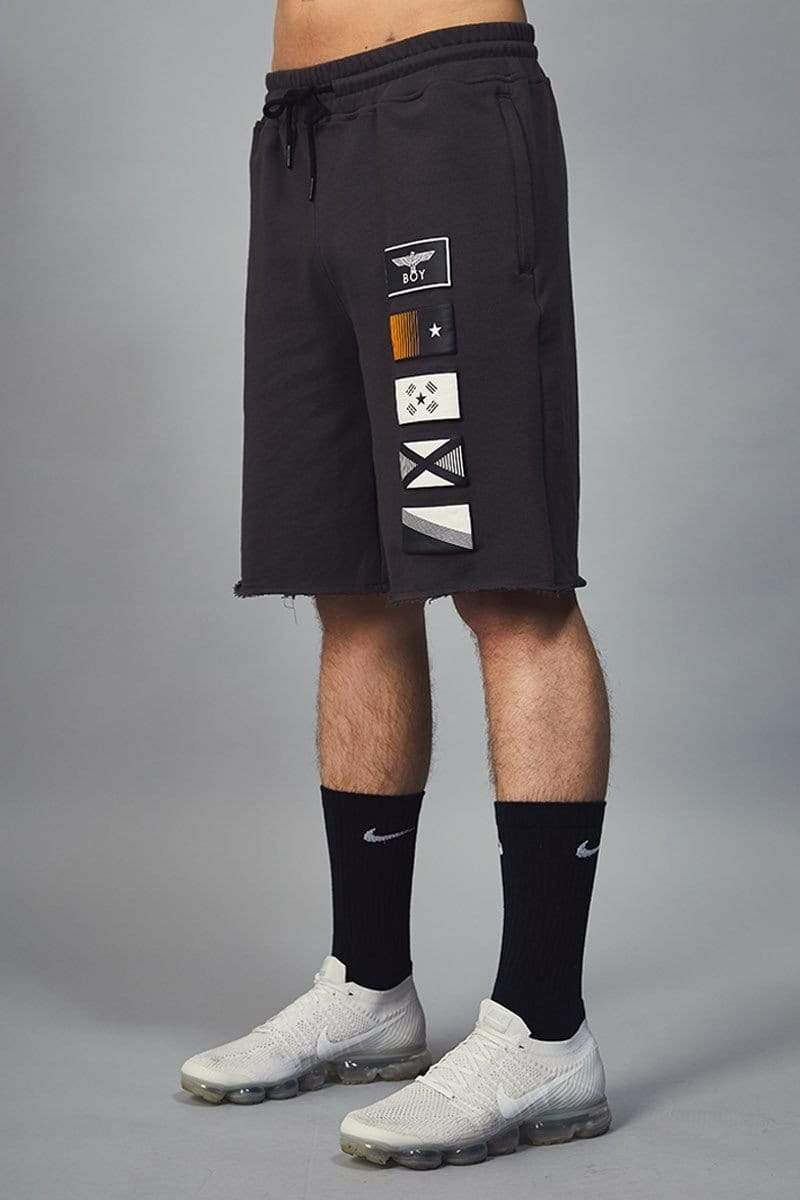 Mid rise jersey shorts in black with five puff printed flag designs. Designed with a drawstring elasticated waistband and three pockets