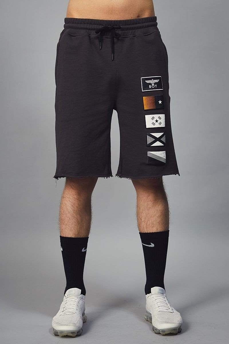 Mid rise jersey shorts in black with five puff printed flag designs. Designed with a drawstring elasticated waistband and three pockets