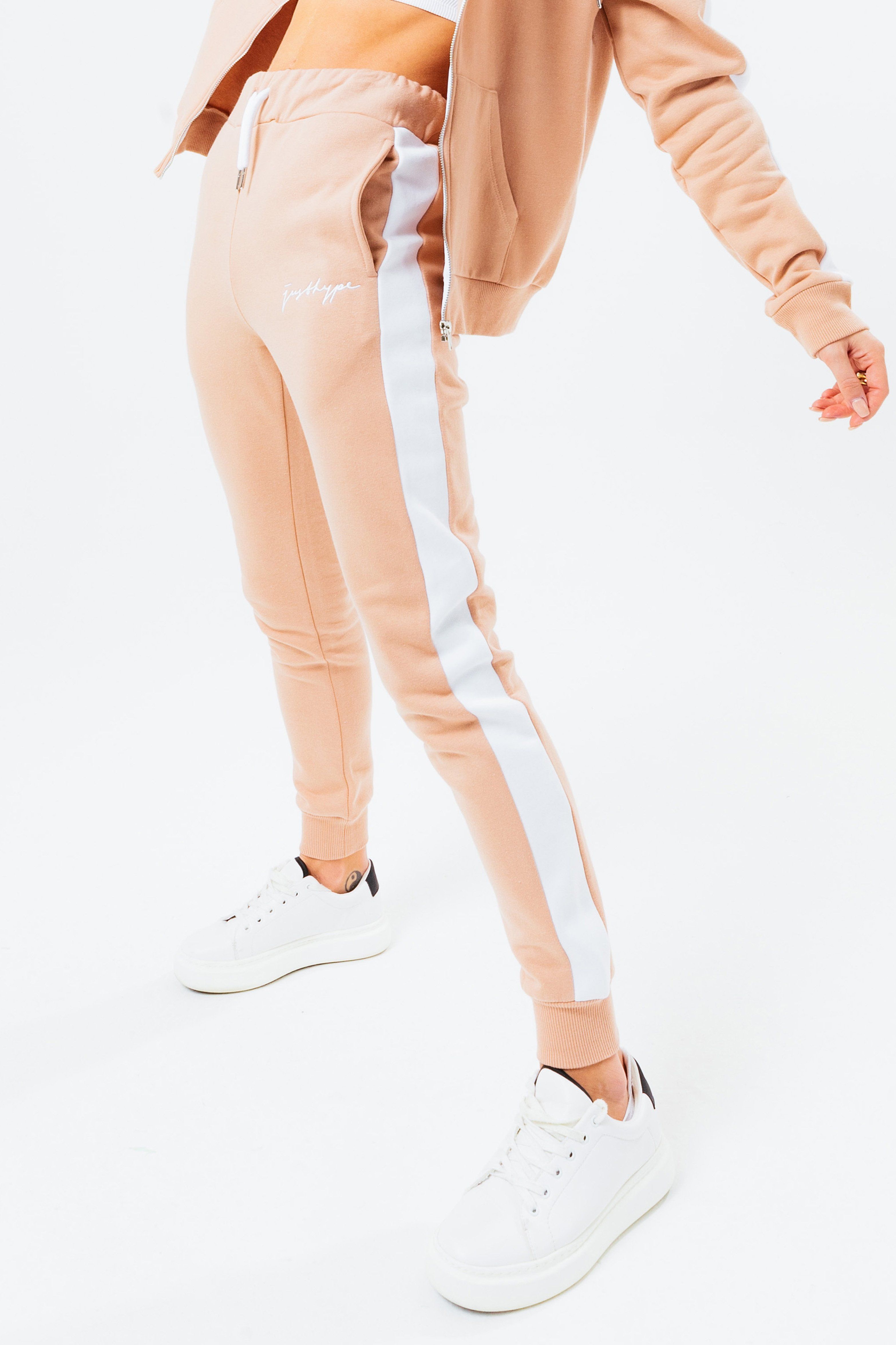 Joggers versatile for every occasion. The HYPE. Chestnut Women's Signature Joggers, available in UK size 4 up to 18, designed in 80% Cotton and 20% Polyester - the ultimate amount of comfort, room and breathable space you need. In our standard women's jogger shape, with on trend contrasting leg panelling, an elasticated waistband, fitted cuffs and drawstring pullers. Finished with the new! justhype scribble logo. Check out the matching women's hoodies and t-shirts in the scribble range, perfect to mix 'n' match your day to night looks. Machine wash at 30 degrees.