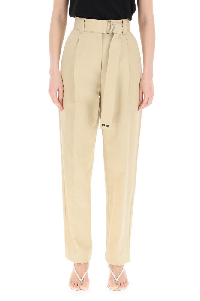 MGSG trousers in cotton and linen canvas featuring a wide-leg cut with front pleats and a slightly tapered hem. High waist highlighted by a removable matching belt with contrasting logo print on the edge. Front closure with concealed zip, side French pockets, rear welt pockets. The model is 177 cm tall and wears a size IT 38.
