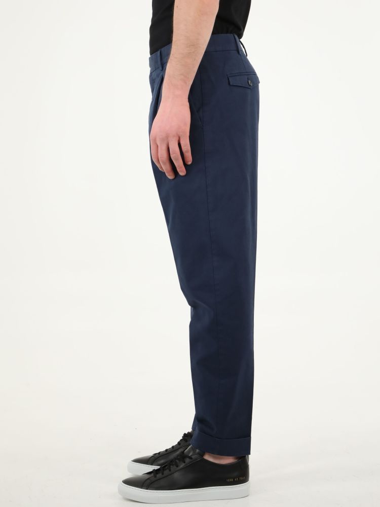 Blue cotton gabardine trousers with straight fit. They feature two side welt pockets, two rear pockets with button, rear charm and belt loops. The model is 184cm tall and wears size 48.