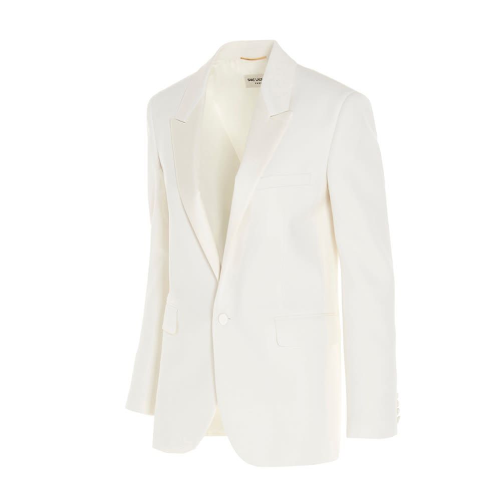 Single-breasted tuxedo jacket in white sustainable virgin wool. It features notch lapels, button closure, two front flap pockets, one welt pocket on chest, two interior pockets, buttoned cuffs and back slit. The model is 176cm tall and wears size 36.  