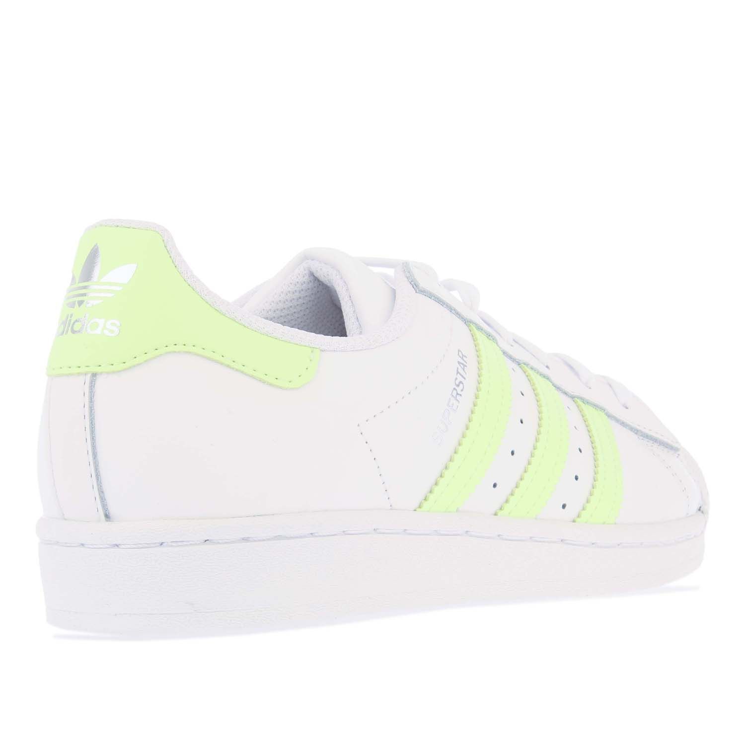 Womens adidas Originals Superstar Trainers in white yellow.- Leather upper.- Lace closure.- Regular fit.- Moulded sockliner.- Serrated 3-Stripes.- Trefoil logos to the tongue and heel. - Rubber sole. - Leather upper  Textile lining.- Ref.: FX6090