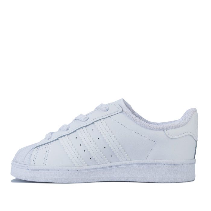Infant adidas Originals Superstar Trainers in footwear White. – Smooth coated leather upper. – Elasticated lace closure for easy on-off. – Classic rubber shell toe. – Padded collar and tongue. – Tonal 3-Stripes to sides and printed ‘Superstar’ wordmark. – Tonal print Trefoil branding to tongue. – Tonal heel patch with embossed Trefoil logo. – Comfortable textile lining. – Removable Ortholite sockliner for comfort and odour control. – Herringbone-pattern rubber cupsole. – Includes set of regular laces. – Leather and synthetic upper – Textile lining – Synthetic sole. – Ref: EF5397