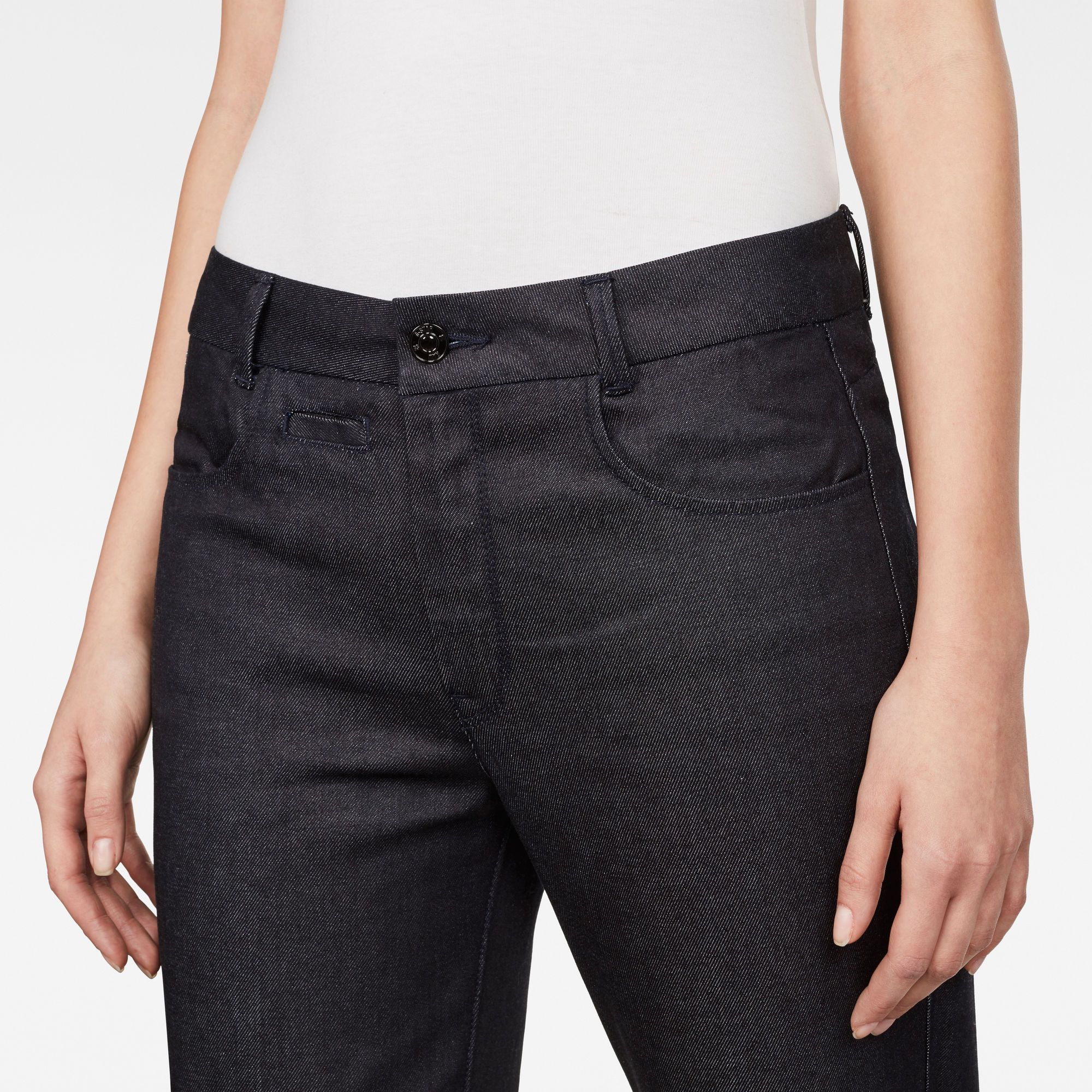 Mid waist. Regular waistband. Narrow from thigh to hem. Zip fly. Zip & button closure. Mid waist. The D-Staq Mid-Waist Skinny Ankle Chino  is cut from full-bodied denim with a surprisingly light weight. Slubby, textured denim. Super-soft hand-feel. 11-dip indigo. Skinny