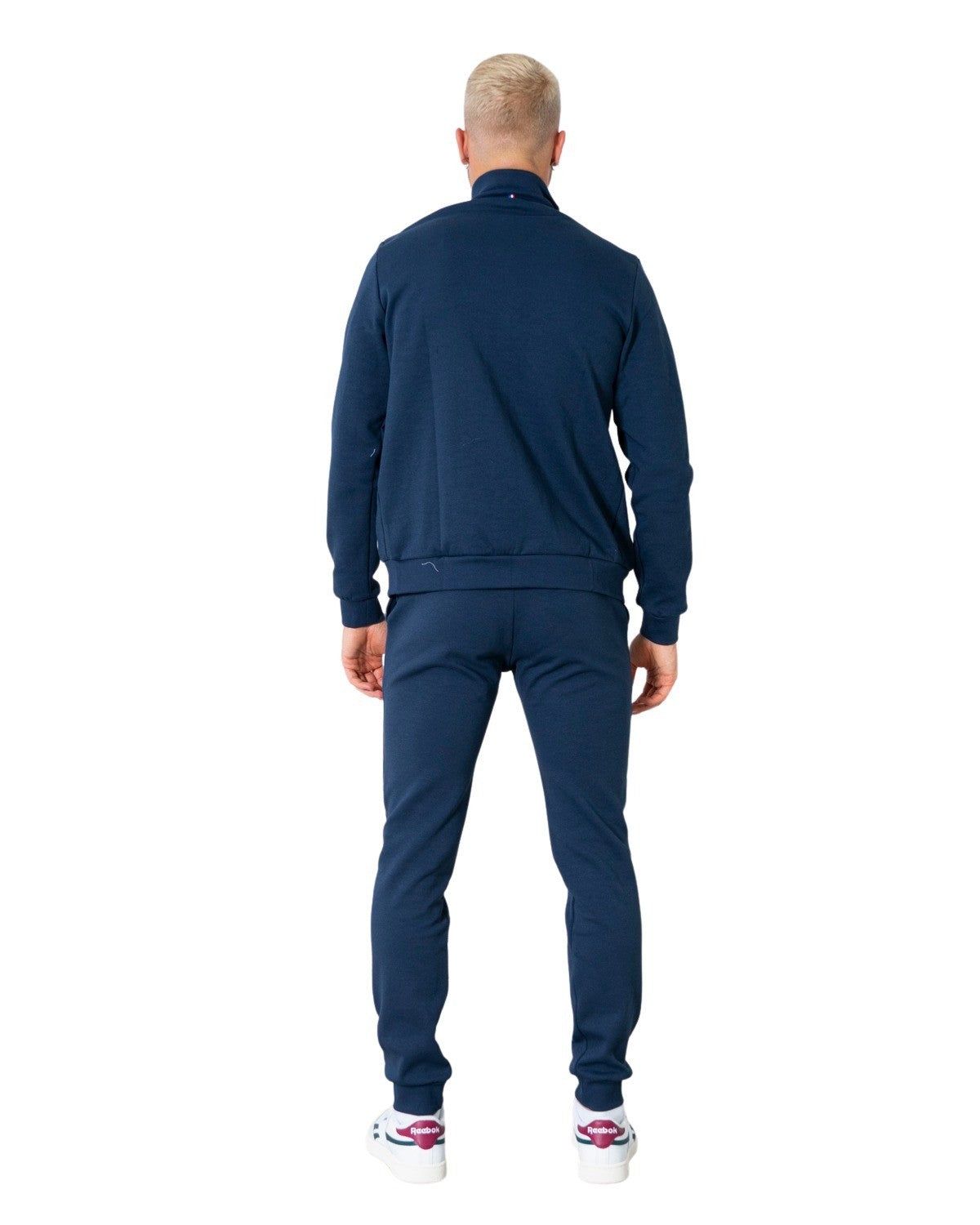 Brand: Le Coq Sportif Gender: Men Type: Sweatshirts Season: Fall/Winter  PRODUCT DETAIL • Color: blue • Pattern: print • Fastening: with zip • Sleeves: long  COMPOSITION AND MATERIAL • Composition: -15% cotton -85% polyester  •  Washing: machine wash at 30° -15% Cotton -85% Polyester