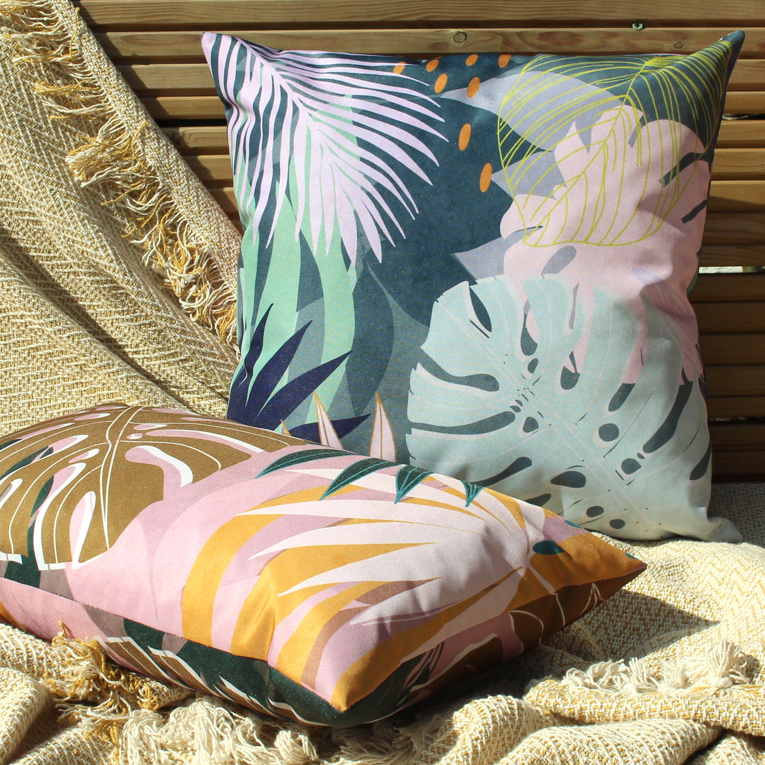 Featuring a bold and abstract design of palm leaves. This fully reversible design in muted blush pinks and olive green's will instantly freshen up your outdoor space.