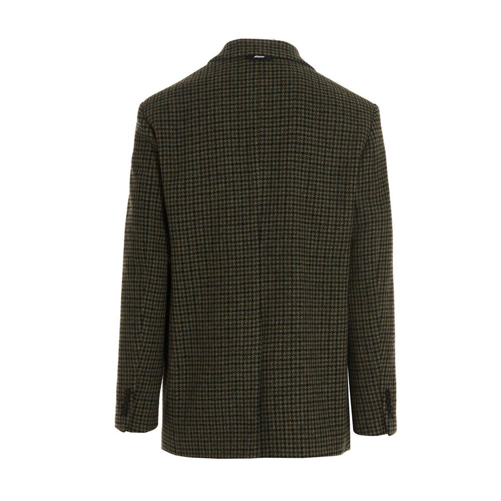 Single-breasted pied de poule wool blazer with notch laces, central split and plate pocket.