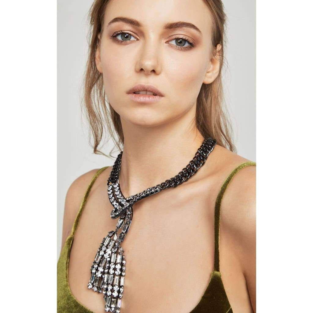 Perfect for highlighting plunging necklines, this statement necklace debuts glistening glass stones and tough-luxe chain embellishments. Adjustable lobster-clasp fastening Materials: 56% iron, 39% brass, 2% acrylic, 2% cerecord, 1% zinc Measures approximately 15” with 2” extension