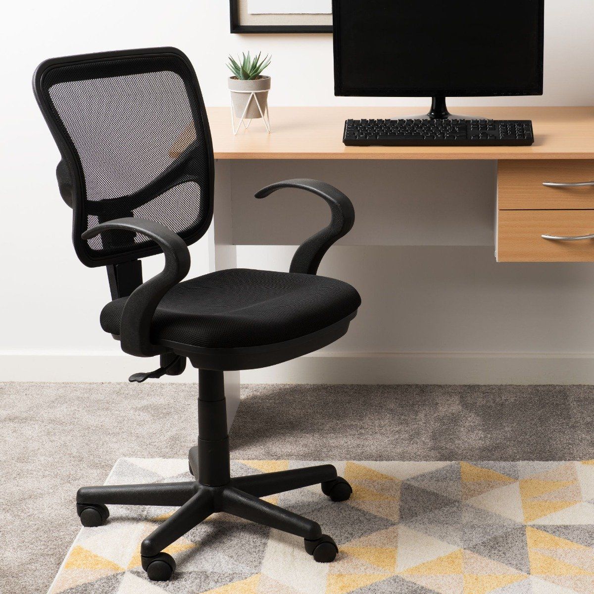 Stylish and comforable computer chair boasting a black finish. 

Height: 61.5cm
Width: 93.5cm
Finish: Foam
Material: Black

Combine comfort and style with the Clifton computer chair. Designed with your back in mind - the chair boasts a foamed seat and mesh back. The perfect addition to your home office, bedroom and livingroom.
