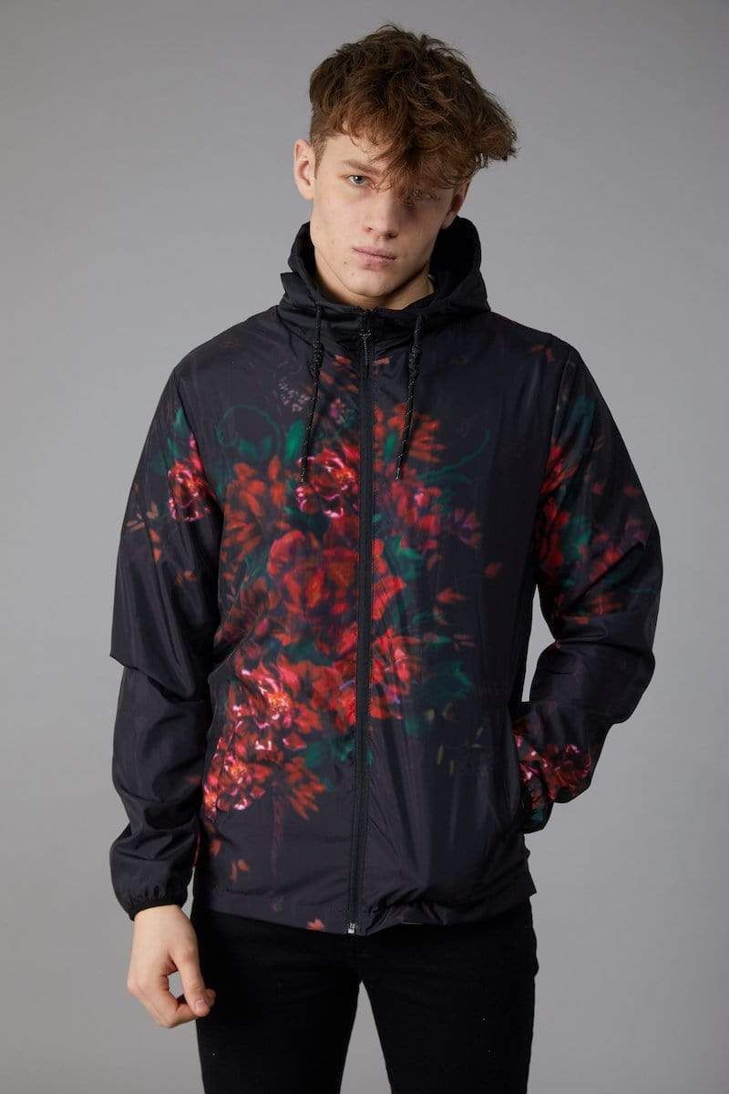 Kai windbreaker with all over red and green floral print, Mesh back panel and CD logo, Elasticated drawstring, Ultra light fabric, Side pockets