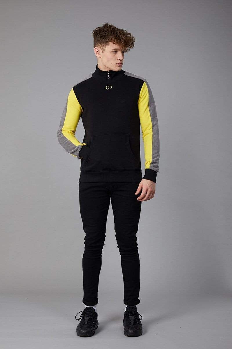 Esteban track top with yellow and grey panels sleeve in black, High neckline zip in collar, Pouch pocket, Embroidered CD logo