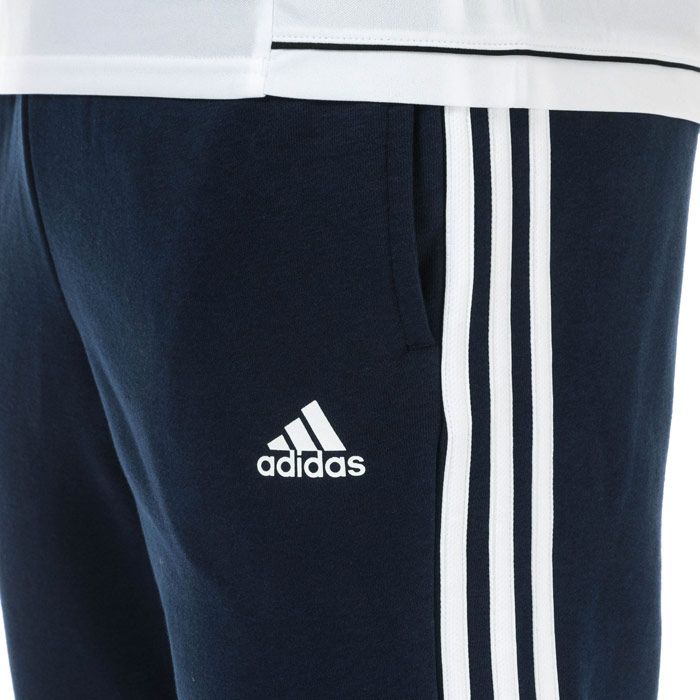 Mens adidas Essentials 3-Stripes French Terry Pants in collegiate navy - white.<BR><BR>- Elasticated waist with inner drawcord.<BR>- Applied 3-Stripes to sides.<BR>- Front welt pockets.<BR>- Open hems.<BR>- adidas Badge of Sport logo printed at left hip.<BR>- Tapered leg.<BR>- Slim fit.<BR>- 70% Cotton  30% Recycled polyester.  Machine washable.<BR>- Ref: CW3883